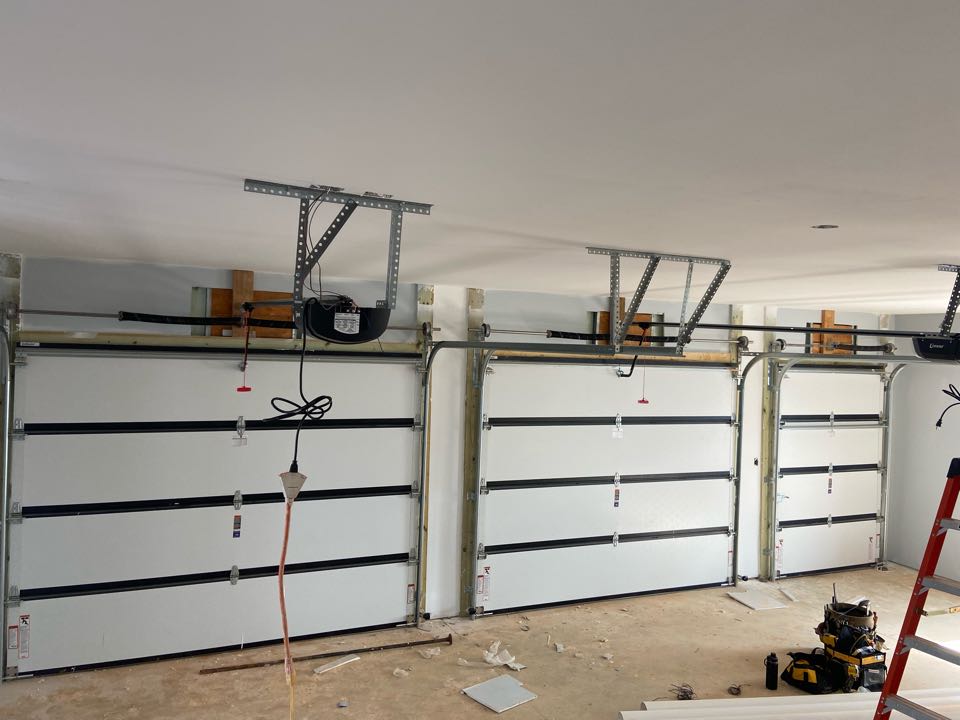 Installed two black steel back insulated Hormann 9x7 single one car garage doors and a 5x7 single utility door. Also installed two Linear DC801 openers with belt rails. 
