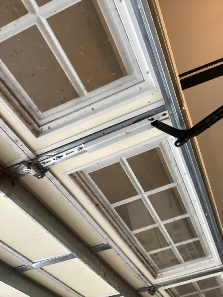 Replaced a standard motor arm bracket with a new one for  single two car insulated garage door.