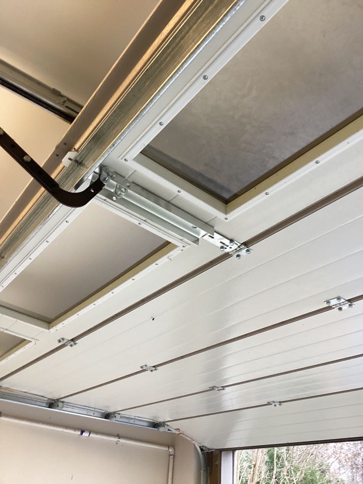 Add a strut across the top of a single two car Hormann garage door and installed a better motor arm bracket to reinforced the top section