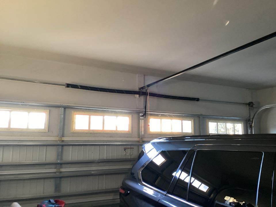 Replaced a pair of broken torsion springs on a single two car metal garage door.