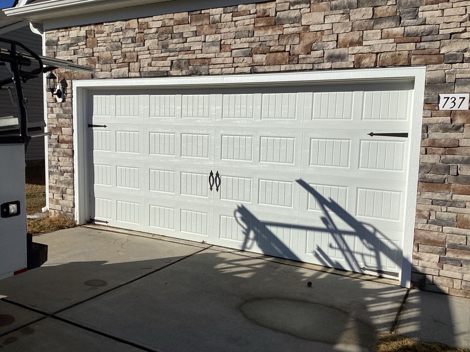 Replace cable on a single two car, metal garage door and serviced garage door and garage door operator.
