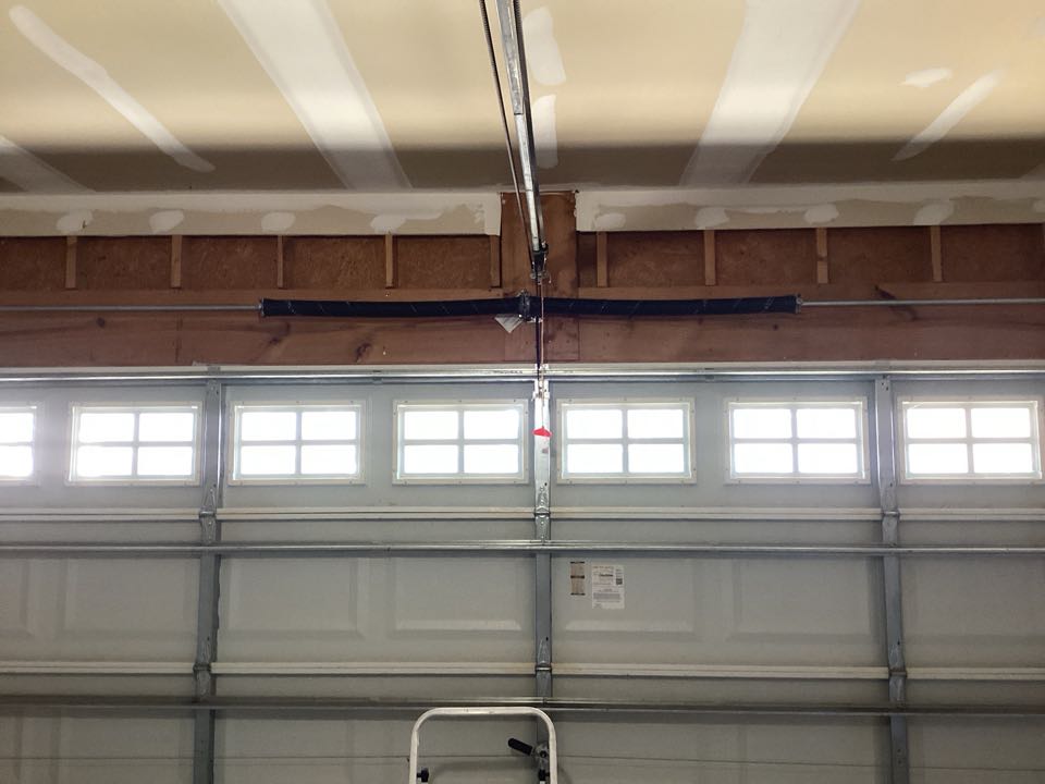 Replaced a broken torsion spring on a single two car metal garage door.