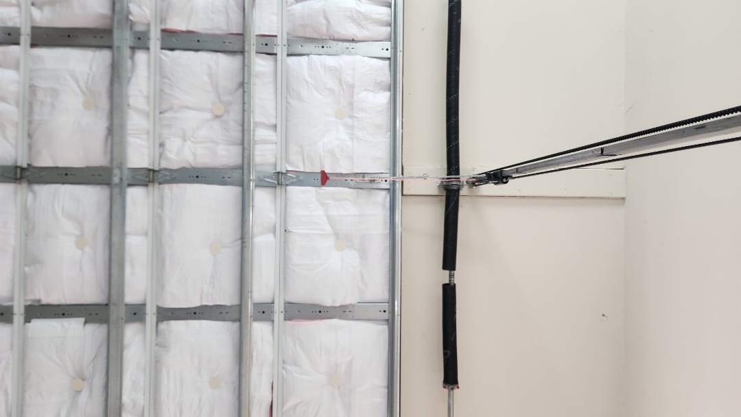 replacing a broken torsion spring on a Wayne Dalton garage door and servicing a Genie garage door operator.