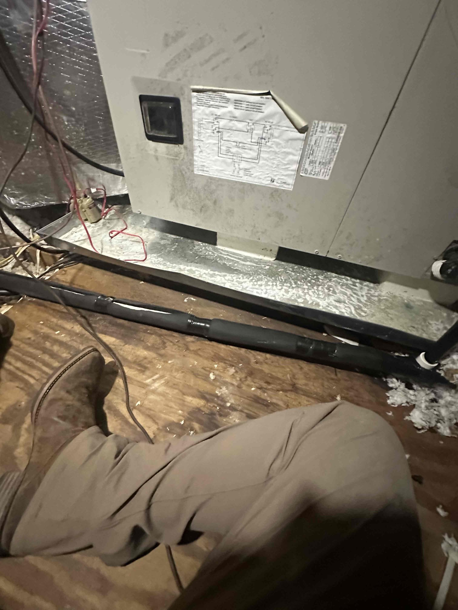 I arrived on the job site and discovered a leak in the ceiling caused by condensation from the drain line. The cold water from the coils was staying in the P-trap and condensing, leading to the leak. I explained the issue to the customer in detail, and they fully understood the cause. The customer requested that I go ahead and insulate the drain line to prevent this issue from happening again. I completed the insulation and ensured everything was secure. No further signs of leaks were observed at this time.