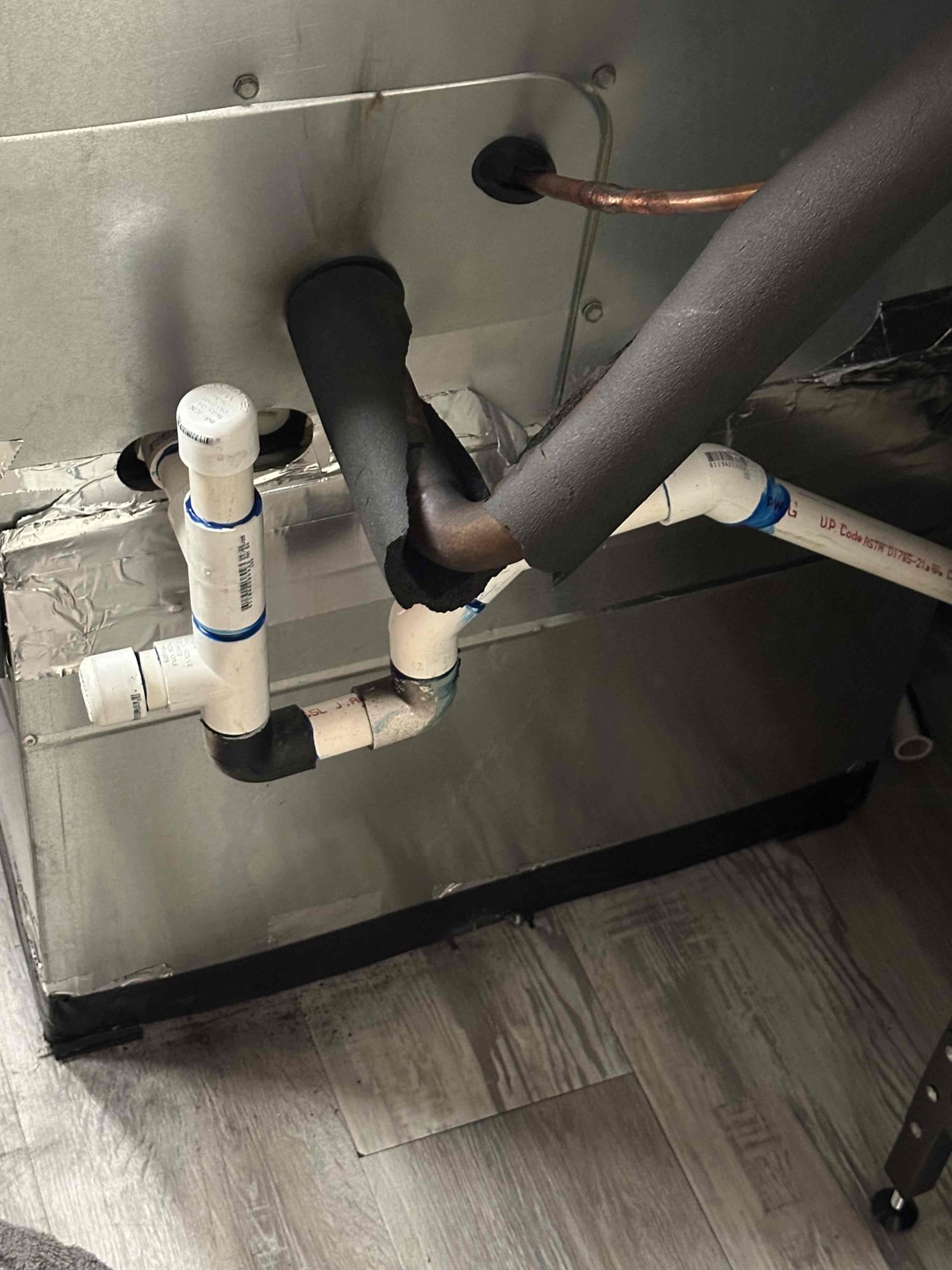 Upon arrival at the job site, a complete inspection of the system was performed. During the evaluation, it was determined that the system is in need of a properly installed auxiliary drain pan beneath the unit due to the finished space located directly below. At this time, there is evidence of water leakage occurring, which poses a risk to the surrounding area.

Further inspection revealed that the existing condensate drain setup is not functioning correctly. The current P-trap and drain line configuration is allowing water to be pulled back into the system, rather than draining properly. As a result, condensate is overflowing the internal pan and contributing to the observed leakage.

It is recommended that we return to reconfigure and properly install the P-trap and drain line to ensure correct drainage and prevent water from being drawn back into the system. Additionally, installing an auxiliary drain pan will provide an added layer of protection against potential water damage in th