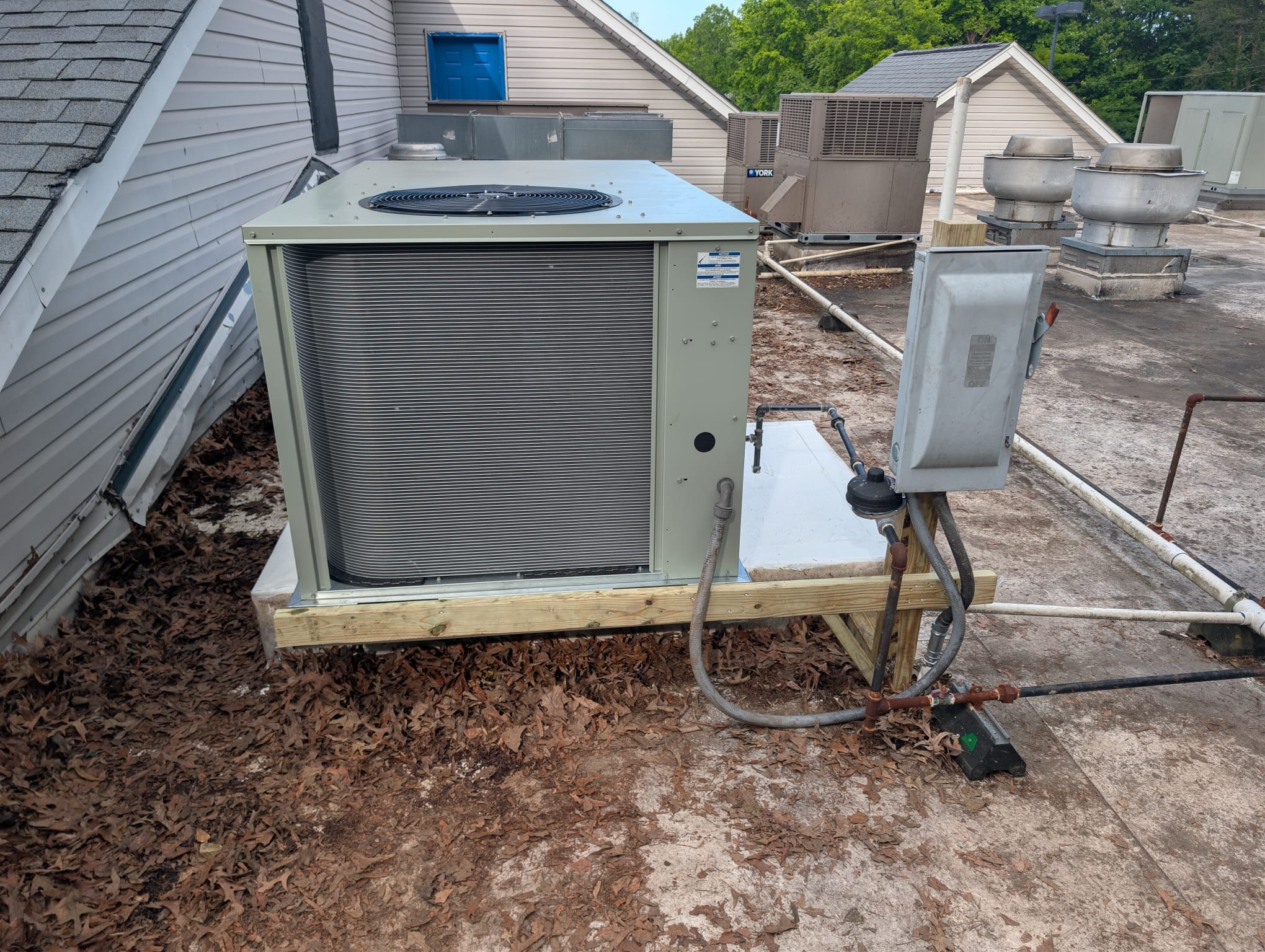 Replaced 10 ton gas package unit with 5 ton gas package unit on roof. Utilized crane. Repositioned unit to reconnect into existing ductwork. Built stand for disconnect. Sealed original curb to prevent rain from leaking into building. Replaced thermostat. Verified operation in cooling mode. System is operational at time of departure.
