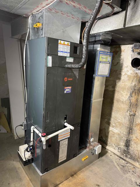 installed new trane tahm airhandler and heat pump outdoor. Built new return and supply. Tapped/caulked return and supply. Ran new power wire and installed new 60amp breaker for air handler. Installed new heat kit and blower surge protector. Installed new condensate line with ez trap and condensate pump. Ran new vinyl tubing from condensate pump to outside. Installed new trane thermostat and wired in low volt with safeties. Reused existing power wire from furnace and installed new outlet for condensate pump. Drilled new line set hole through concrete wall in basement. Ran new line set and connected to new equipment. Installed new trane heat pump on leveled pad and snow legs. Installed new disconnect with surge protector and wired into outdoor unit. Cleaned up work area and tested out equipment. Will have to return to complete ductwork modification and remove oil tank. Customer wanted to pay after we remove both oil tanks and job is complete. 