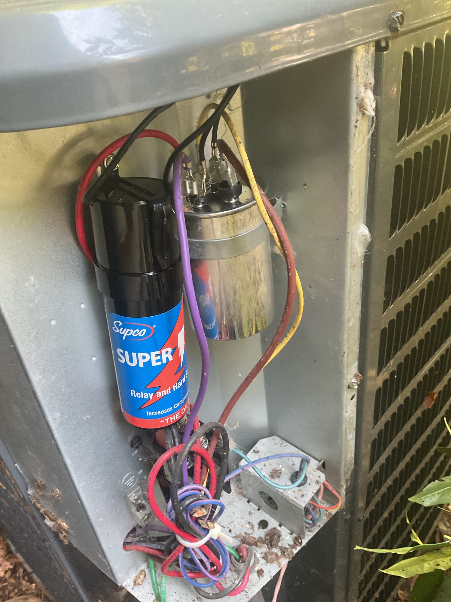 Fully assessed no cooling situation. Found failed 45/5 capacitor. Provided solutions to replace just the capacitor or replace the capacitor and add a hard start to assist the compressor on start up to help with longevity of the compressor, homeowner went with this solution. Installed and tested operation of a/c. Also homeowner mentioned that his furnace does not always start up on first try, found burners very rusted and corroded recommend replacing with stainless steel burners to prevent corrosion. Check 410a refrigerant pressures they were  223/128 with 5.7 subcooling. Could smell propane while we were outside we found a leak at fitting on propane tank and told him to contact the propane company to repair. A/c is working properly at time of service. 