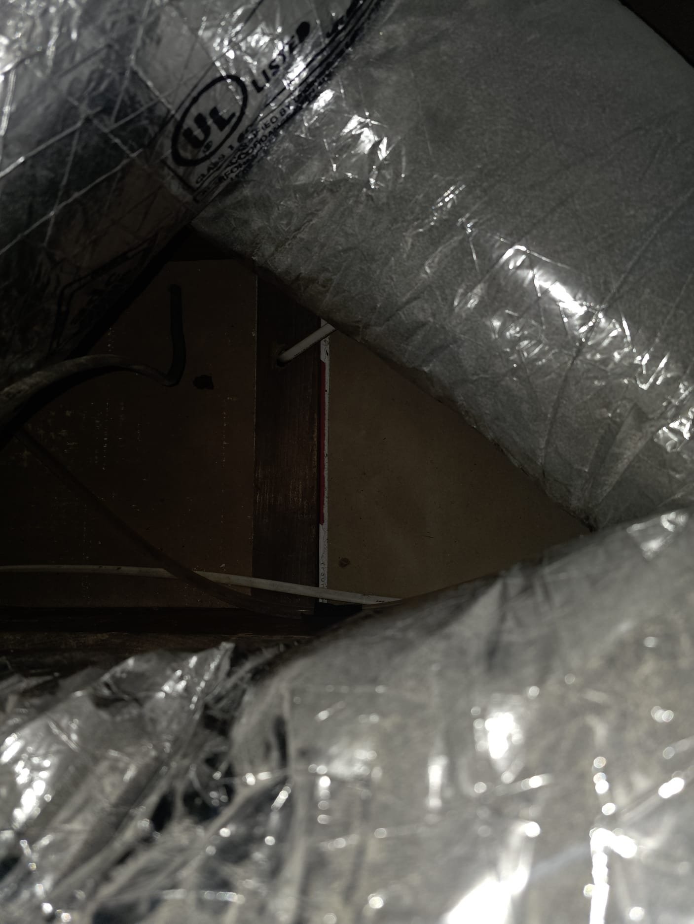 Reviewed installation for attic gas furnace and ac installation.  Trunk system is bubble wrapped and could not see how well sealed the main trunk is.  Flex ducts come off of system, most likely there is wall stack feeding the first floor.  Covered all of the supply vents for registers and connected the fan to the return.  Turned on system and ramped up the pressure to 25 Pascals.  Measured duct leakage.  Found several areas of leakage around cabinet and return connections.  Sealed with tape.  Remeasured at 181 cfm25.  