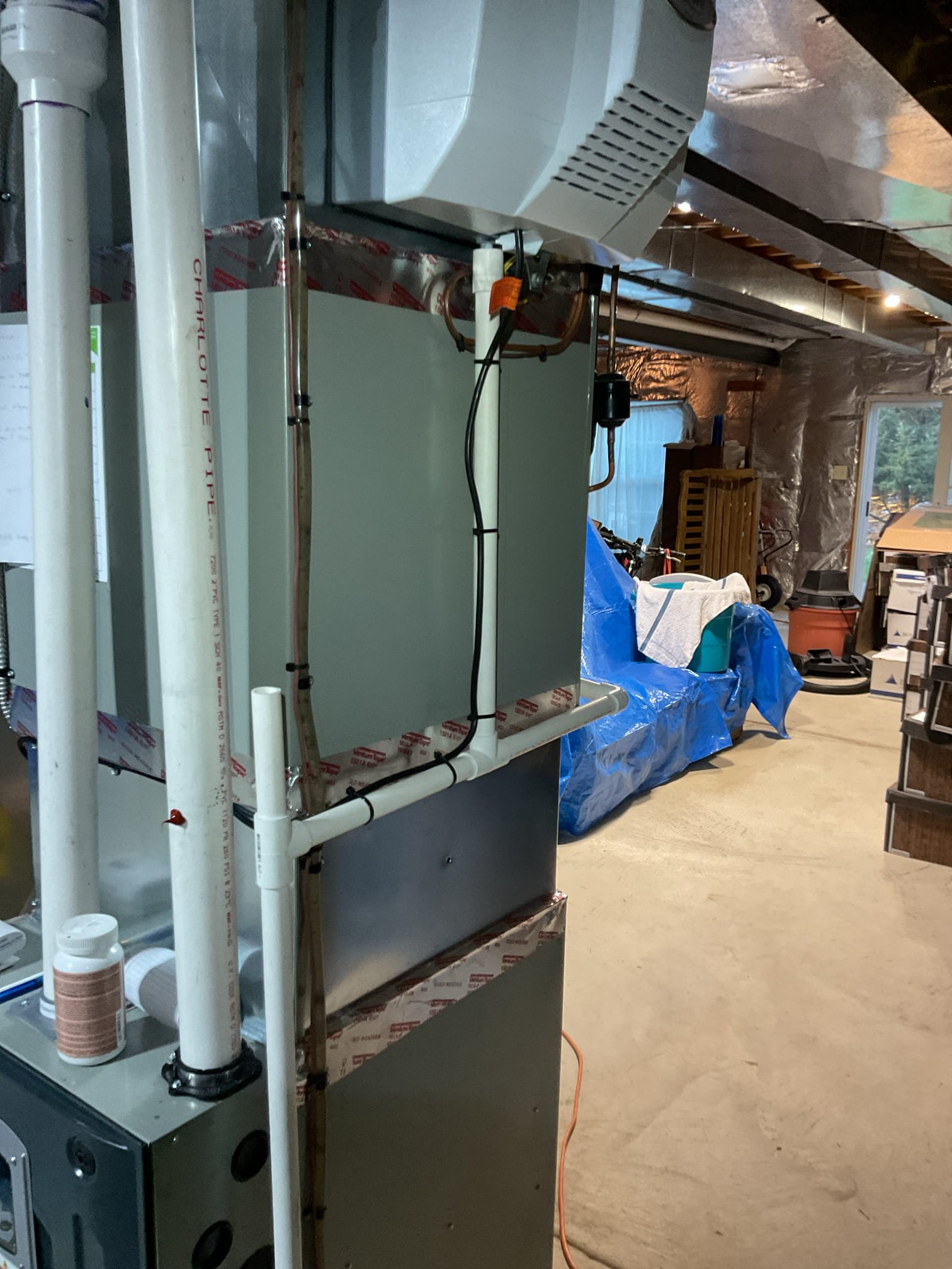 Powered humidifier leaking at system we installed last Friday.
Drain was piped in series with the AC drain which in some cases especially in high static pressure or high airflow scenarios may prevent the humidifier from properly draining.
I ran humidifier drain separately to an open spot of the condensate pump.

Then checked over system.
Found heating fan speed to be one speed too high set for 1830 CFM. Set fan speed to 1620 option based on capacity of furnace (100,000 BTU)and the airflow performance chart. This could have been part of why humidifier was not draining properly as well.

After adjustments I ran system with demand for humidity for approximately 10 min. No leaks. 

System operating well at this time. 