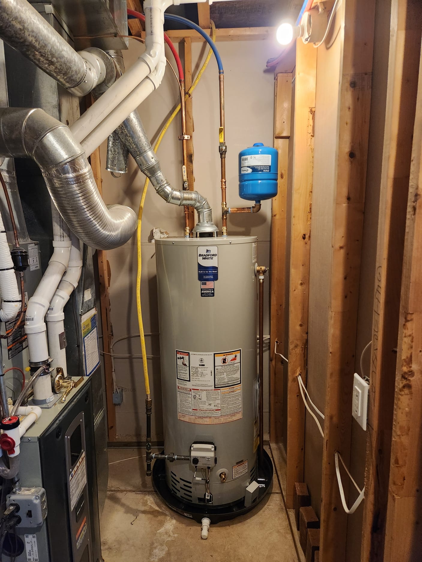 Drained and removed existing water heater. Set new 50 gallon gas water heater in new drain pan with water alarm. Adapted hot and cold sides to new water heater including new brass tee nipple and 90 for new expansion tank. Filled water heater lit pilot flame and ensured proper operation 