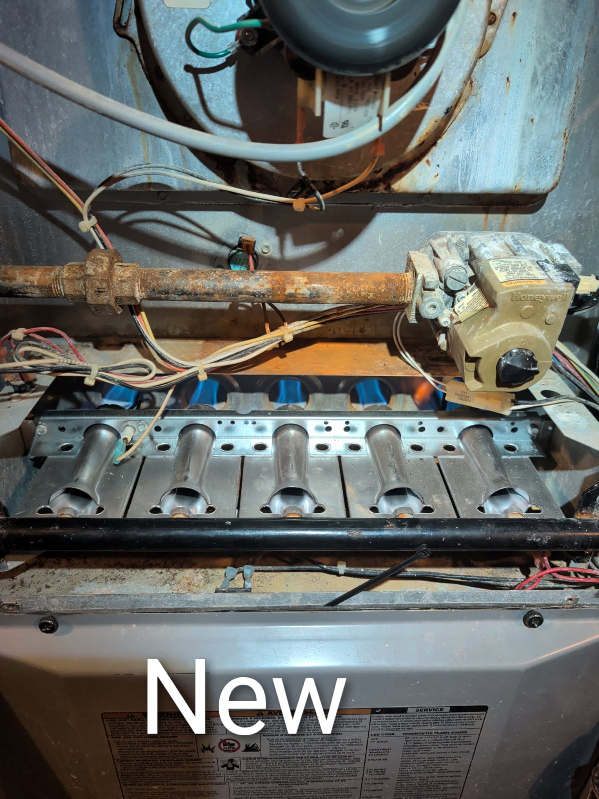 Removed original burner manifold.
Vacuumed rust from burner compartment with manifold removed.
Installed new burner manifold.
Replaced female spade connector for flame sensor.

Afterward tested system operations: temperature rise and combustion analysis: Good

Also forced open a manual damper to the back bedroom.

Wants an estimate Minisplit for the garage and possibly add (2) other heads one being to the 1st floor back bedroom and the 2nd floor master bedroom. 

Zoning would involve 
(1) 8x20 bottom mount trunk damper, 
(1) 8x18 side mount trunk damper.
Wireless or 2-wire thermostat for second floor and all new controls. See previous job for photos of dampers. 

I reminded them that I recommended upgrading HVAC system. 19.5 years old. Parts are very expensive at this point and will be difficult to source. 

Furnace operating well at this time.

Office follow when you can to set up consultation. 