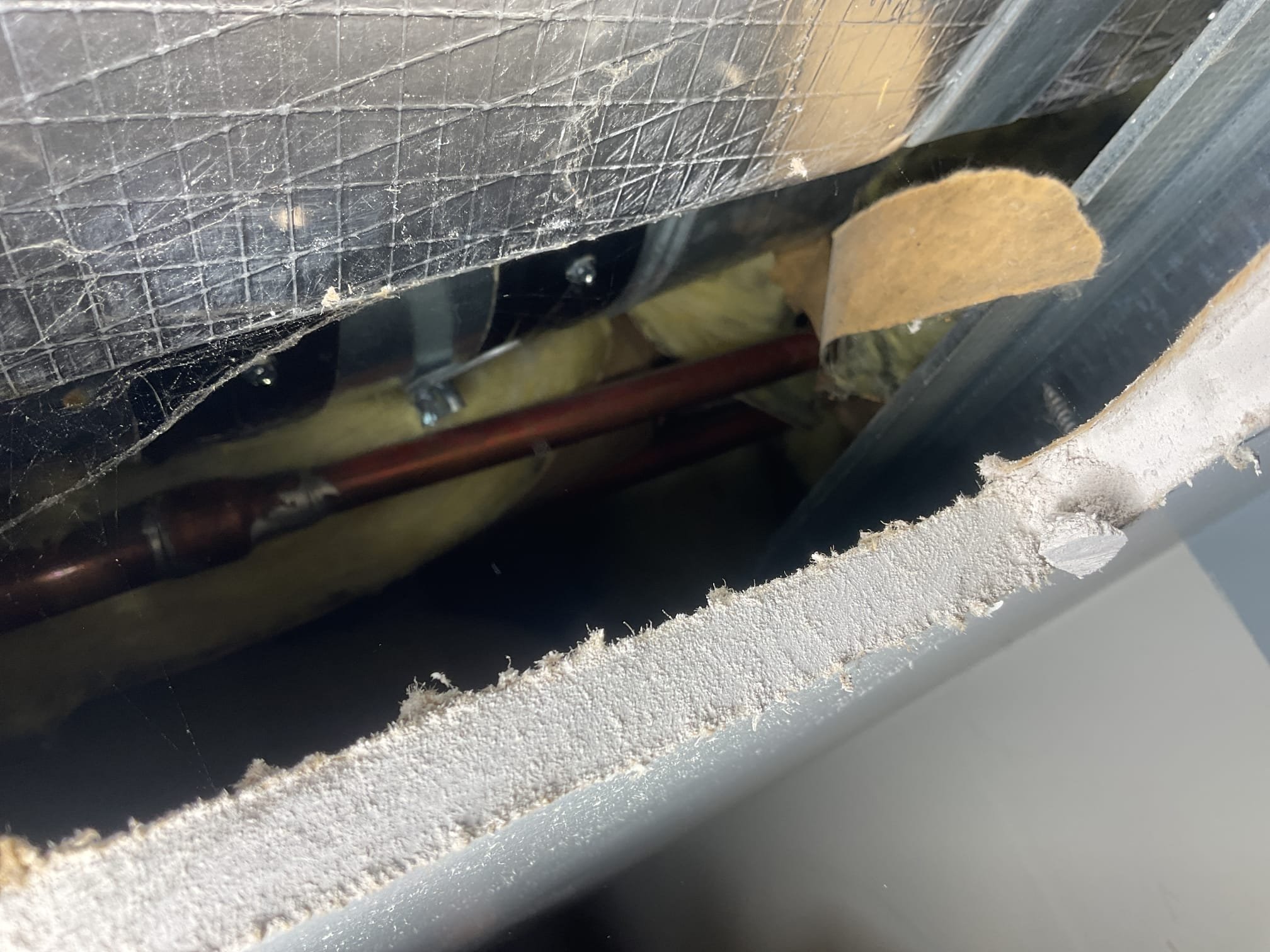 Cut access in drywall to open damper based on customers confirmation of location. We are not responsible for patching hole. 12/31/25. Used camera and cut acces holes. Found closed damper for duct run for office. Opened up damper and now there is heat coming out of the register. Vacuumed up drywall dust. Collected ballance. 