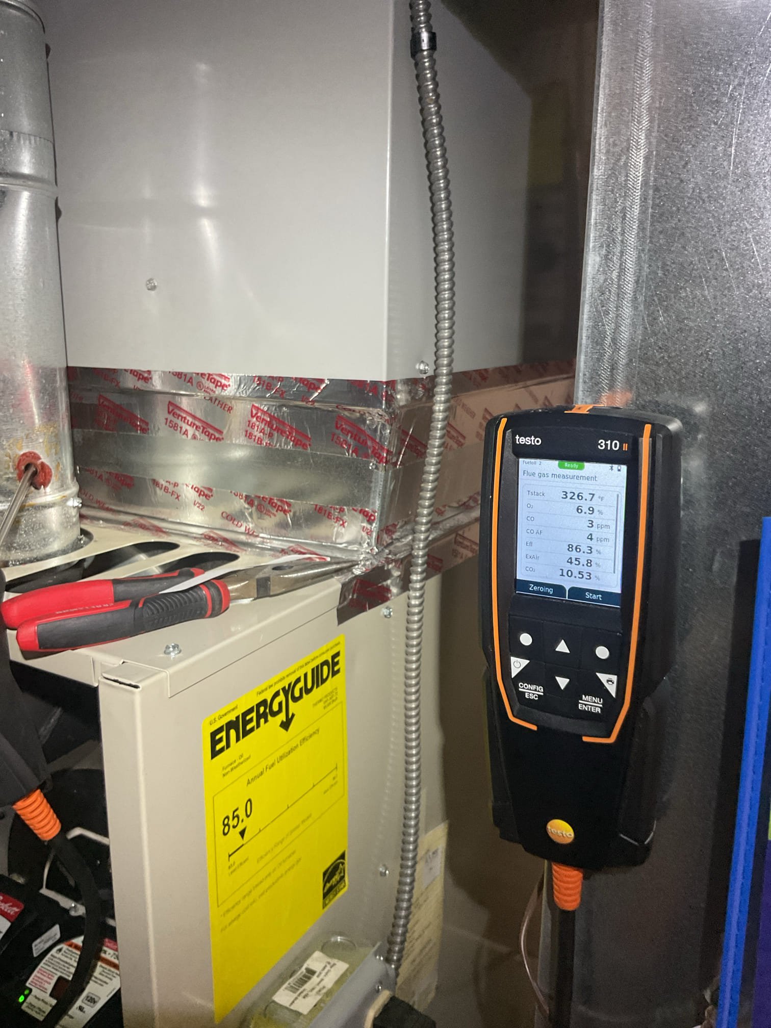 Neighbor came over and told me she can smell oil. Duplex house. She lives on the other side. Robert doesn’t come down to basement often 

Found copious oil in equipment pan, blower compartment and filter rack.
Cleaned as much as possible and left paper towels to absorb oil that is under furnace where I cannot get to it.
Replaced failed wet switch.
Used (2) burner gaskets folded in half and placed under bottom half of burner so that burner is pitched in such a way that oil will spray into combustion chamber. Changed post purge time from 0:00 to 1 min.

Completed oil Heat tune up.
Replaced Aprilaire 413 filter. 
Heat exchanger and flues are clean.
Replaced RF1 oil filter, replaced .60 80A nozzle and arranged electrodes.
Combustion smoke and draft test: Pass

Set new humidifier to 35%. Pad is new. Tested operations and water leaks. 

We will have to make a return visit to pick up the towels that are used to wick up any oil left in pan and assess the oil leak situation further.
After my fi