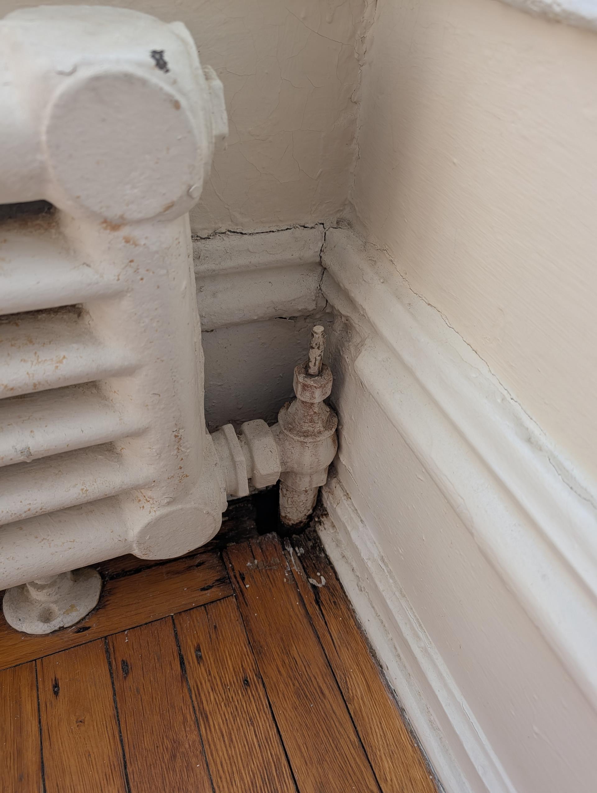 Boiler was overfilled.
Drain approx 12-15 gallons to get water level to design.
Checked over wiring,

One big issue has been thermostat location it is in a corner about 10’ up on first floor where there is a breeze from entrance way. The temperature there is 7° cooler than the temperature in any of the apartments themselves. 
We installed Honeywell S1200 Elite pro thermostat with equipment interface module and a room sensor.  
Placed the room sensor on a wall in a second floor apartment and configured new thermostat to use this sensor as the temperature input.
Set thermostat target 70°
Monitored boiler operations.
Set auto water feeder delay period to 10 min.

Tightened packing nuts on 3 problem radiator valves. They were very lose. 

There are a couple air vents that need to be replaced. We will provide estimate. 

System will run alot less often now by virtue of having temperature being read from an actual apartment. 
