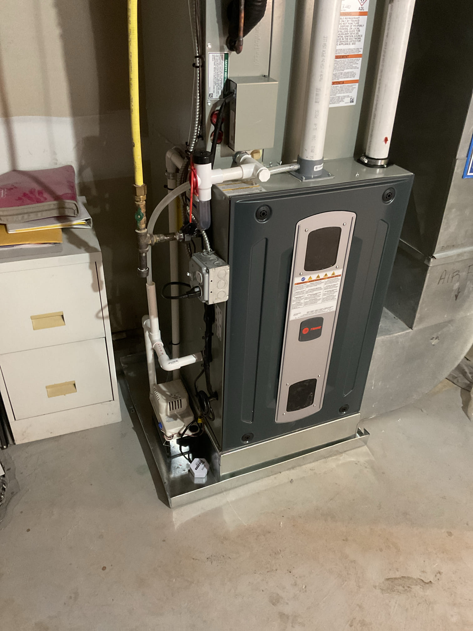 Recovered refrigerant and removed and disposed of old equipment.  Installed new Trane furnace and air conditioner on new pad and leveled.  Completed all metal work to furnace and ran new vent system in 3" pvc from furnace to outdoors with flush termination kit.  Connected all mechanical and electrical connections to indoor and outdoor units.  Tested furnace operaiton.

We will need to return to install new dampers, zone panel, and thermostats.

2/10/26
Conner and Barry
Installed (2) New zone dampers (1) 8x12 and (1) 8x18 there is one more zone valve that is still original (8x12 for backside trunk of zone 2 second floor zone). Will talk to management about price and replacement of this one. 
Installed new Zone panel and configured 
Installed (2) HoneywellS1200 thermostats, configured for high efficiency gas heat 2-stage. 

There is one room sensor she can chose to link to either of the (2 thermostats). She may use for first floor because there is lots of sunlight beating down on thermos