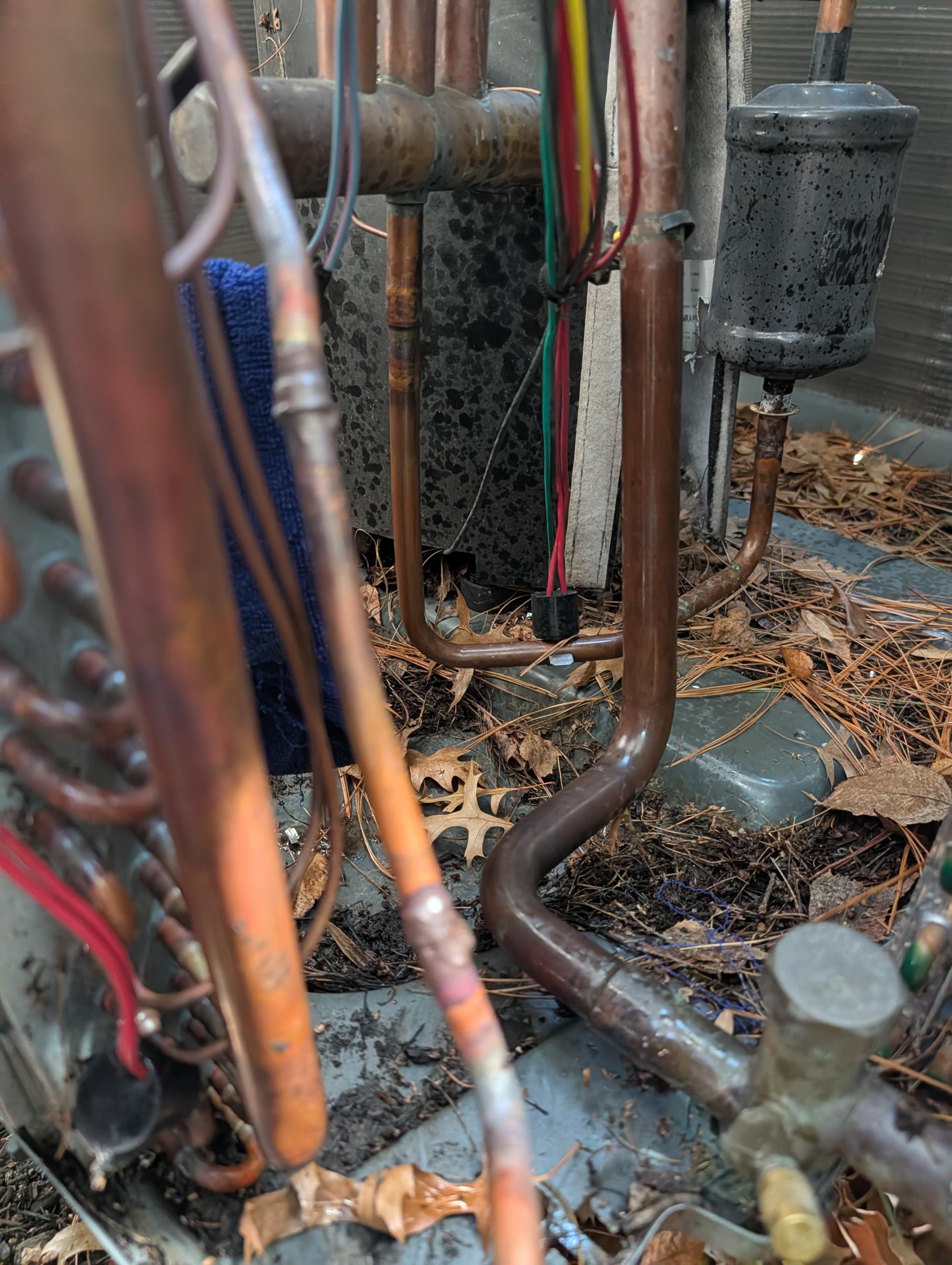 Replace indoor coil under part warranty (Non-warranty price for repair is $3624.40)

           *  Recover remaining refrigerant.
           *  Remove and replace indoor coil with warranty coil.
           *  Complete all mechanical connections to coil.
           *  Pressure test system and soap test joints for leaks.
           *  Evacuate system to below 500 microns.
           *  Weigh in factory refrigerant charge.
           *  Test system operation 
           *  Adjust charge by adding refrigerant as needed.
           *  Process warranty with distributor for credit fort new coil.

3/10/26
Released remaining nitrogen in system.
Removed failed leaking indoor coil 
Installed TXV in new coil and placed back on original drain pan.
Brazed in new indoor coil
*Also Removed filter drier and installed 3/8 refrigerant copper in its place. Installed new filter drier at more accessible location outside unit.

Afterwards pressure tested with dry nitrogen to 345 psi and I could heat hissing 