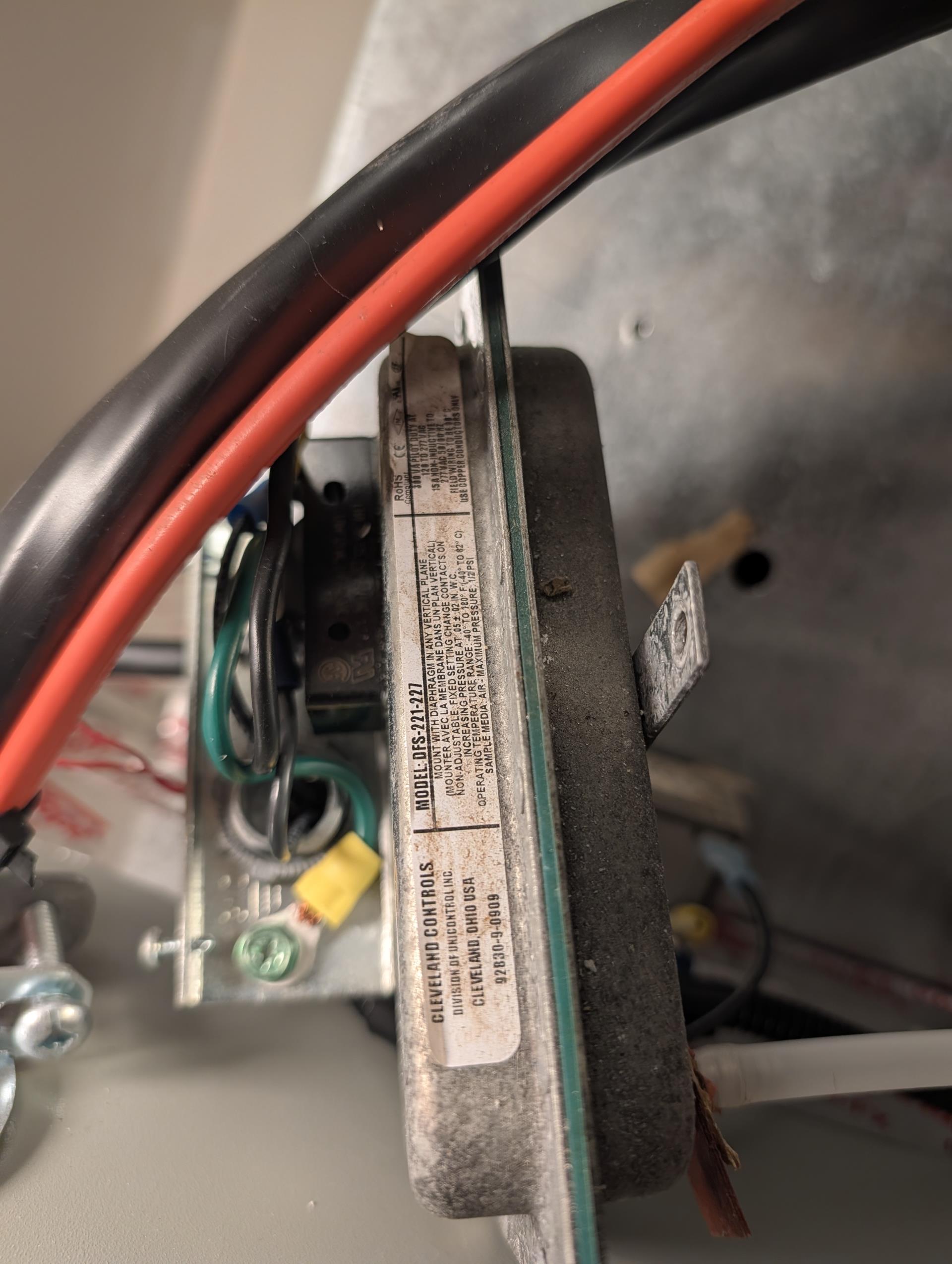 There is an air proving switch that controls the Aprilaire air cleaner AND a booster fan.
The air proving contacts and diaphragm are intermittently opening and closing. 
I took air proving switch off and blew lightly into air tube and exercised the diaphragm.

It is a 120V air proving switch I uploaded photo of the model and wiring of the switch. 

We will provide estimate to replace this switch.

Not covered under any warranty. Was installed by Big Nate and Joe in 2010.
