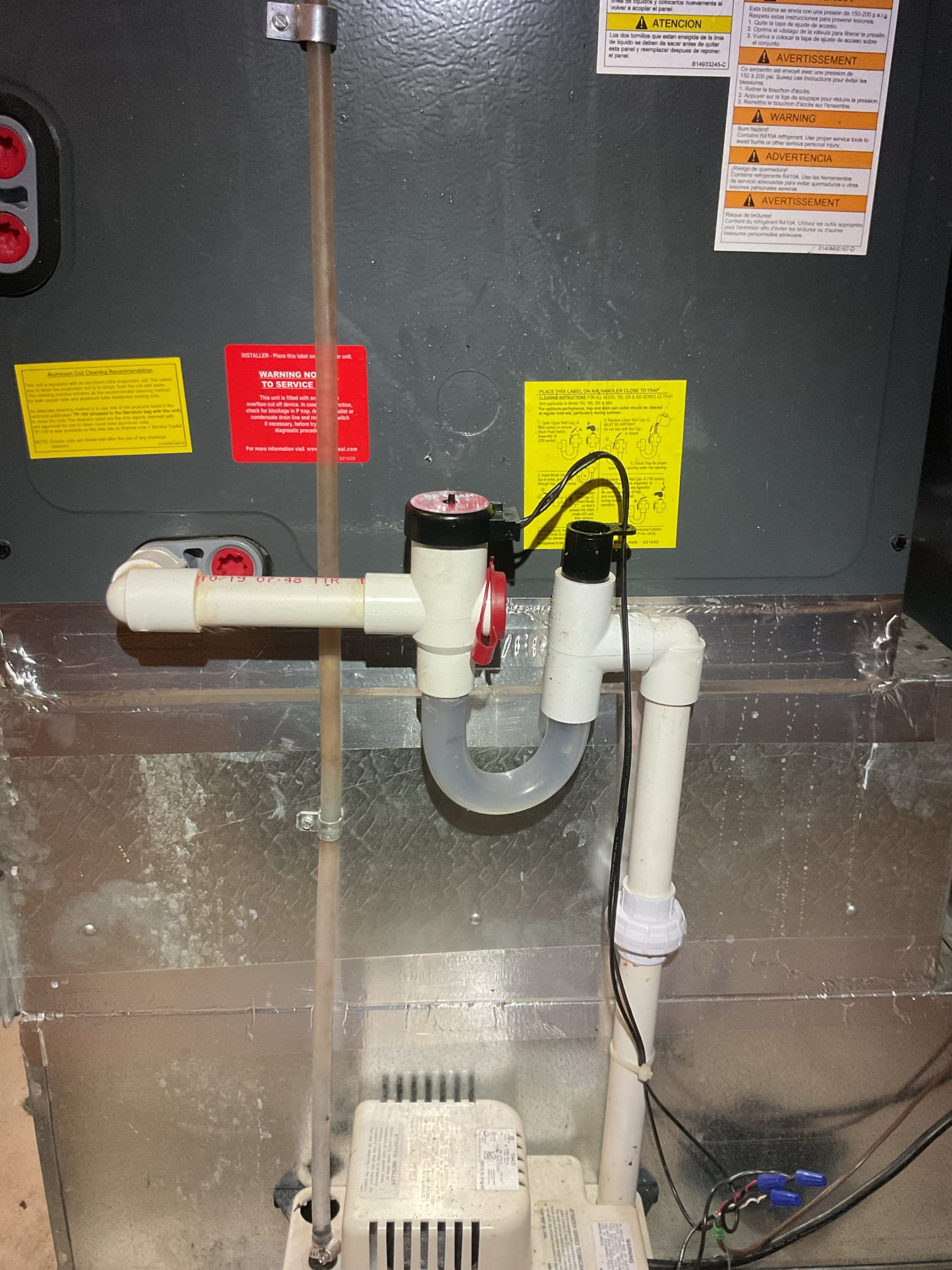No cooling.
Found drain clog situation causing an open EZ trap switch. I explained how the EZ trap works. There is a float switch at the top of the trap so that if the drain becomes clogged/obstructed the float rises and an electrical switch breaks power to the thermostat.
Showed homeowner how to brush out trap.
Flush drain line and tested pump.
Added condensate treatment tabs. Showed homeowner how to do this as well. Vinegar can be used as an alternative to the tabs to keep drain line and pump clean.  Only needed in cooling season.

AC system operating well at this time. 
 