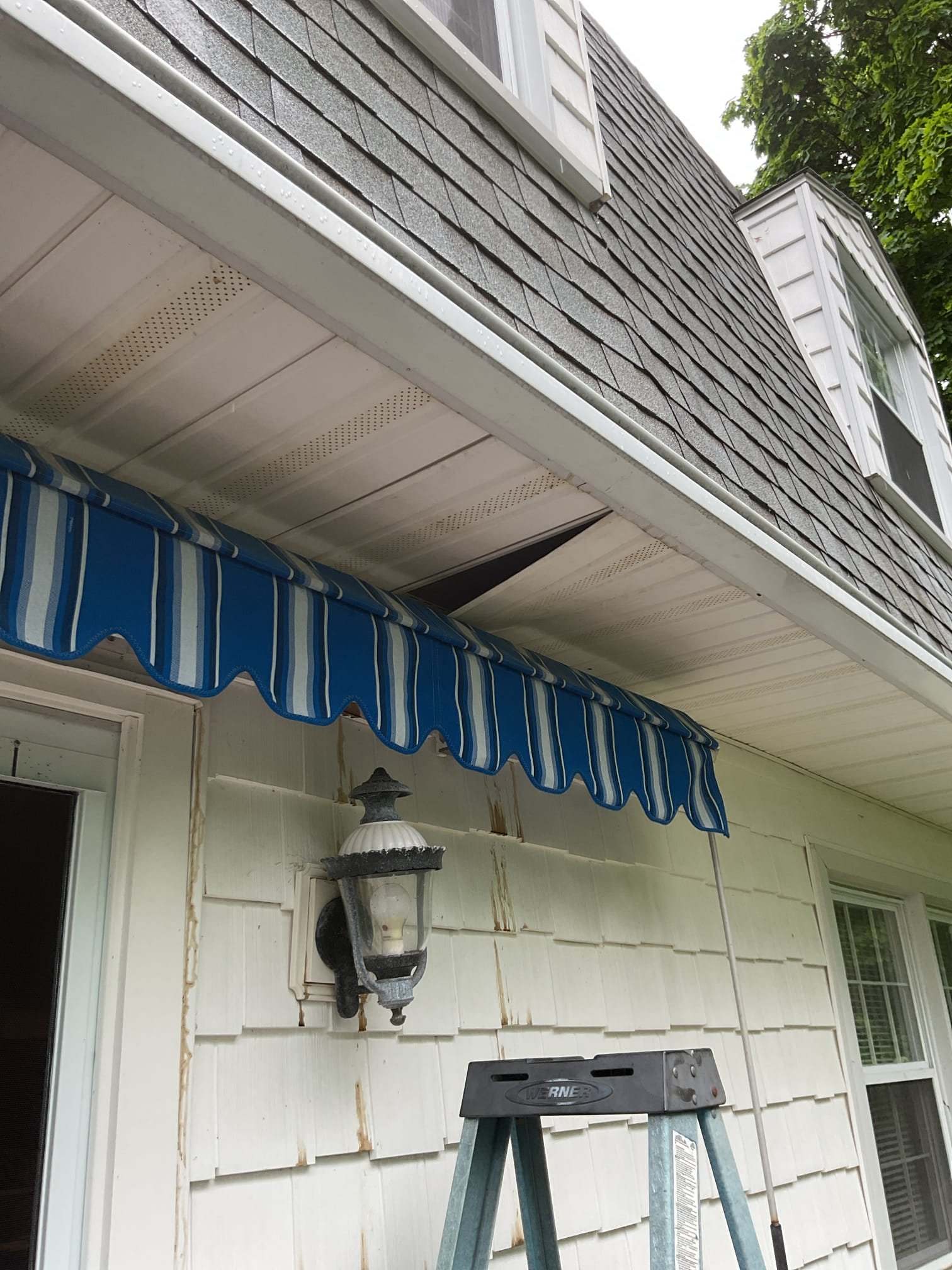 Issue is dark color stains on white siding back side of house around deck.

Roofers, plumbers and a wildlife control person have t been able to pinpoint scat cause.

I checked attic air handler. No signs of water leaks and the drain runs perpendicular to the side of house with Lineset. 

Used inspection camera and popped piece of soffit off that the wildlife company did and noticed that the water leak marks are coming from the piece of wood that the gutters mounted towards the wall NOT from direct,y above. I located the piece section of hydronic baseboard immediately above where these water marks are and scoped between two bedroom walls where 3/4” copper for baseboard runs and connects the 2 sections. No water leaks at all.

I also checked boiler pressure 

I believe the gutters and the wood they are mounted to are the culprit. 
If gutters get loaded with snow and freeze as happened this past winter AND the wood they are mounted to is slightly rotted, the gutters can detach slightly le