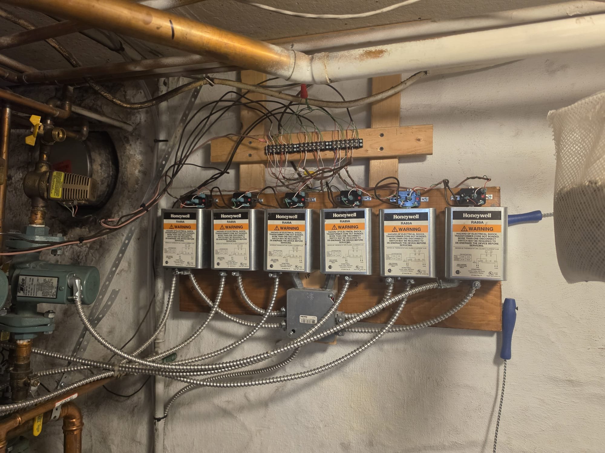 Reviewed wiring for boiler system and found when one zone is calling that multiple zones are coming on. Tested removal of boiler from wiring to see if the same problem persists. The same thing was happening. There are two transformers, one on the zone circ relay and one on the boiler that may be crossing paths. Installed six isolation relays above the boiler relays and rewired the system to energize the isolation relay off of the thermostat and wire TT from the pump relays to the normally open contact of the isolation relay. Tested each zone to ensure proper operation. 

The transformer for the system is 75 VA. If all 6 zones are calling, the load on the transformer may exceed the rating. It would be best to upgrade the transformer to a 150 VA transformer. The customer is okay with doing this in the fall before the heating season. 