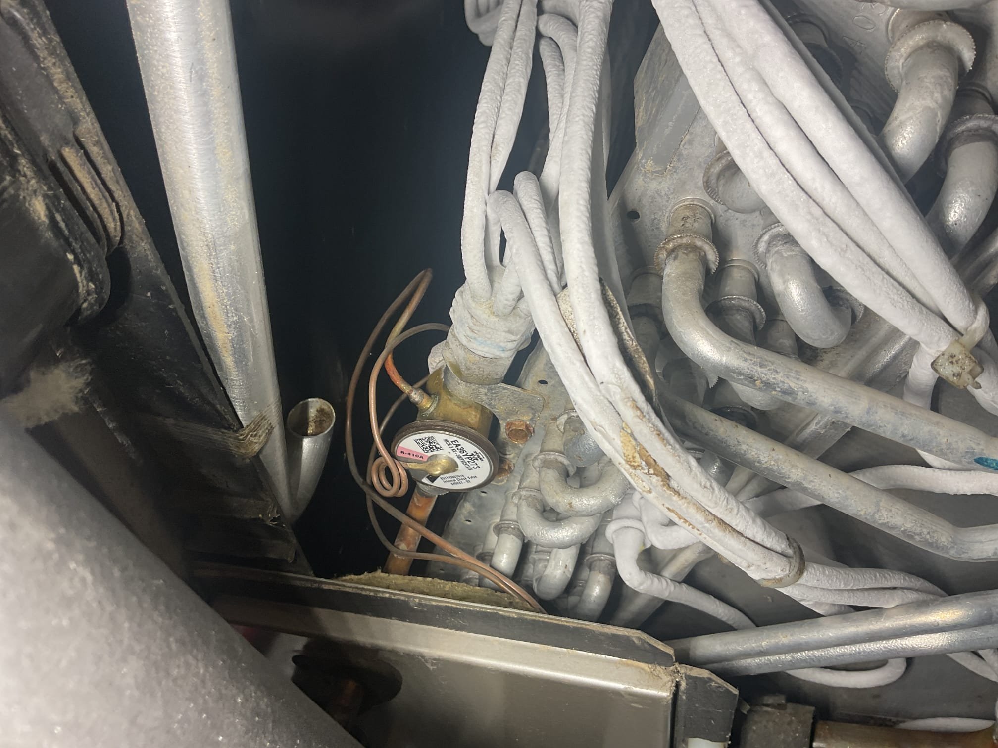 7/23/26. Started to add refrigerant to the system. 410a pressures were 228/98. Suction pressure started to plummet as soon as I began to add refrigerant dropping the entire way down to 52 psi on the suction side and the distributor lines began to freeze after the indoor txv, failed indoor txv. Called distributor and found that the part is still under warranty. Ordered the part. We will return to install once part comes in. 