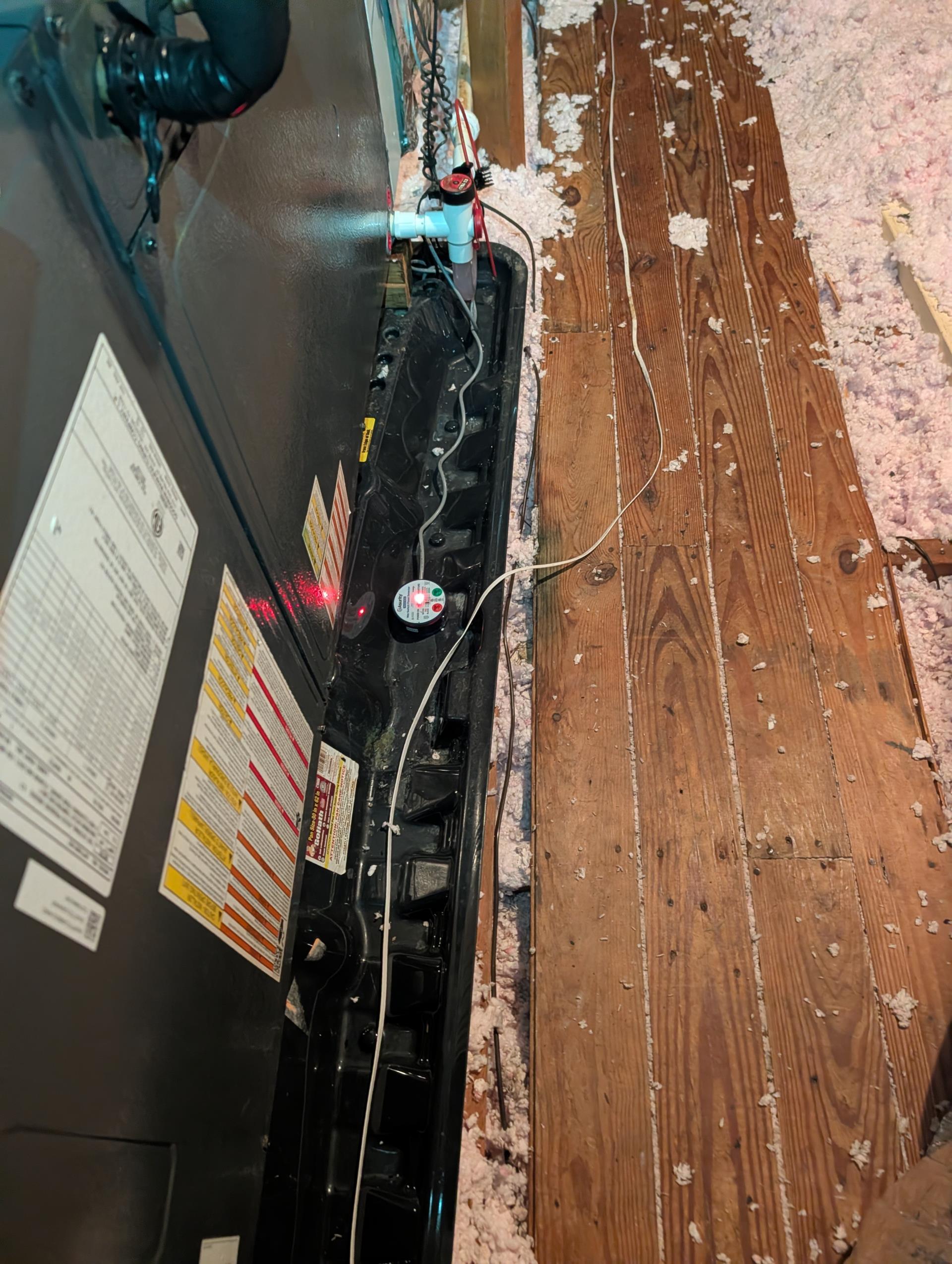 The cause of the blank thermostat was nuisance trip of the wet switch.
It is exceptionally humid and hot in the attic.
Wet switch produces a tiny bit of condensation creates a small pool of water enough to trip the switch and break power to the thermostat.
Placed switch on a zip tie riser and checked drain, drain pan and flow of drain water to the termination point behind and to the left of outdoor unit.

System operating well at this time. 

