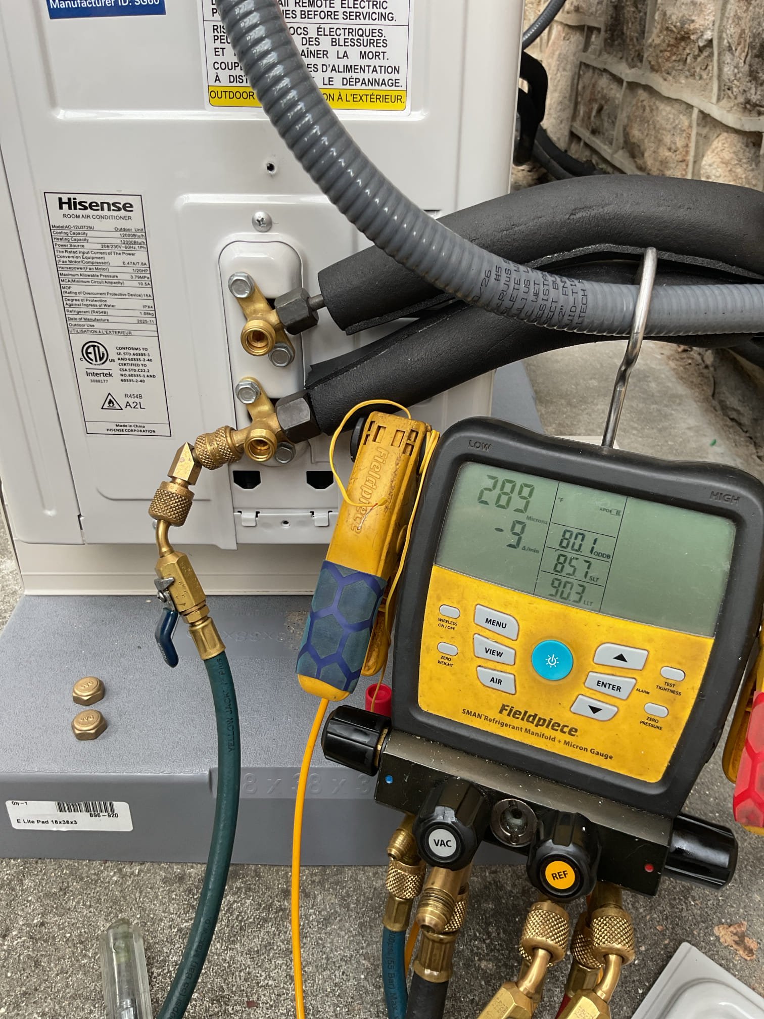 Completed install.
Used tandem 20A breaker to replace (2) single pole 20A circuits and rearranged breakers on right to installed new 15A double pole to feed this unit. Torqued all lugs to 25 in/lb per breaker specs. 
Installed condensate pump with new 1/4” tubing, wired in safety.
Pressure tested system to 350 psi nitrogen
Evacuated system to 230 microns, decay test passed: stayed under 1000 microns with pump valvesd off (720)
Opened valves and tested system in cooling pressures and temperature split ok.
Made sure indoor head is pitched and tested drain by pouring water directly into drain pan. Pump is very quiet.
Set power monitor according to 206V circuit (190 under-voltage) (226 over-voltage) 
Replaced schrader core

System operating well at this time.

Installers could have left notes as to what was and was not completed. 