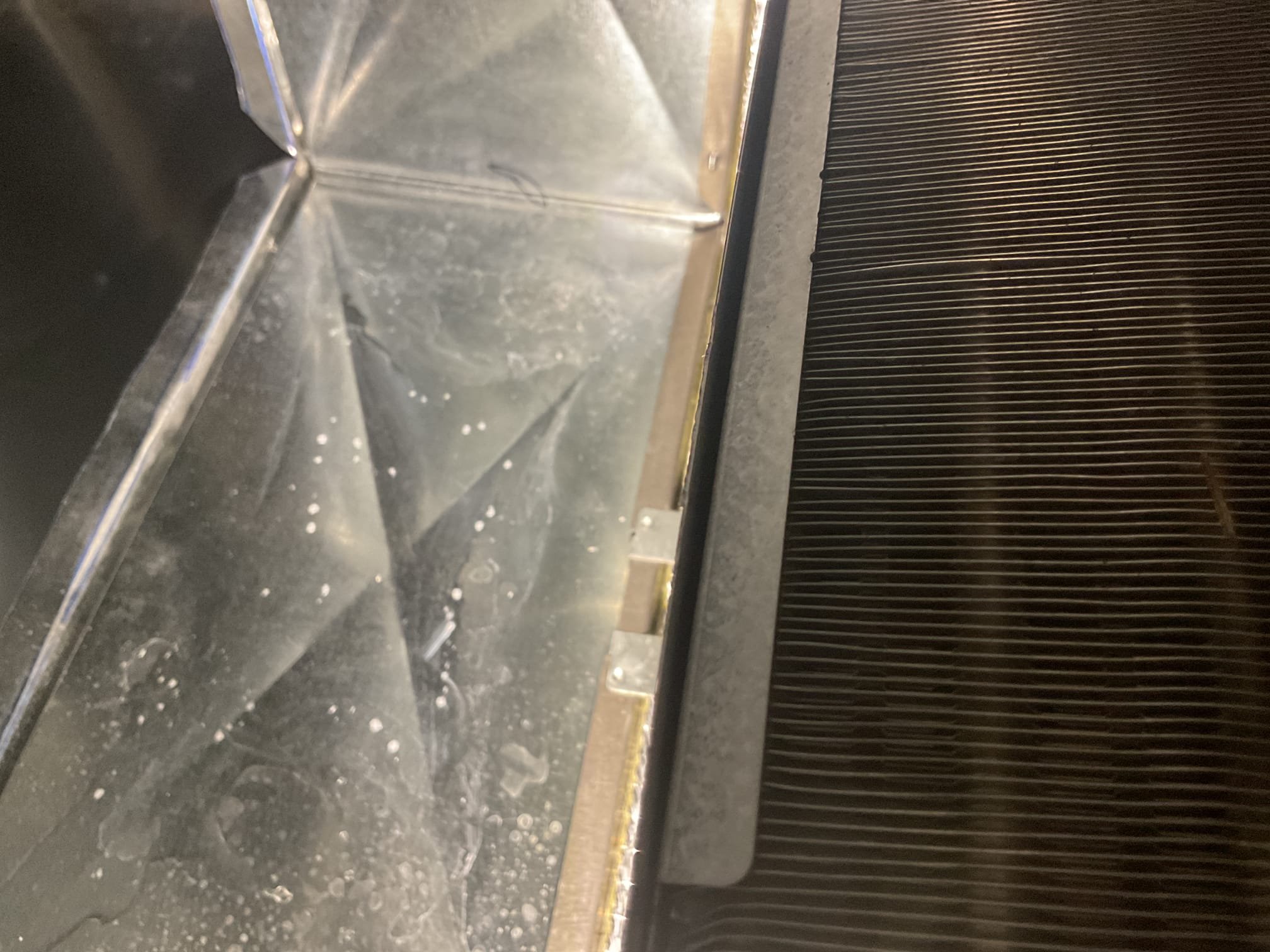 9/15/26. Found water leaking onto drop ceiling from recently installed trane a/c and gas furnace horizontal. Took apart coil door and poured water in drain pan to test operation, drain pan drained out completely. Motor on system is an x-13 blower motor with speed tapping. Air flow is set on tap 8 and outside a/c is a 5 ton. Speed tapping 7 drops down to around 1400 cfm which is to low. Need to see if trane makes a splash guard for this coil and need to install it on both units that were recently installed and get back to the church about splash guards. 