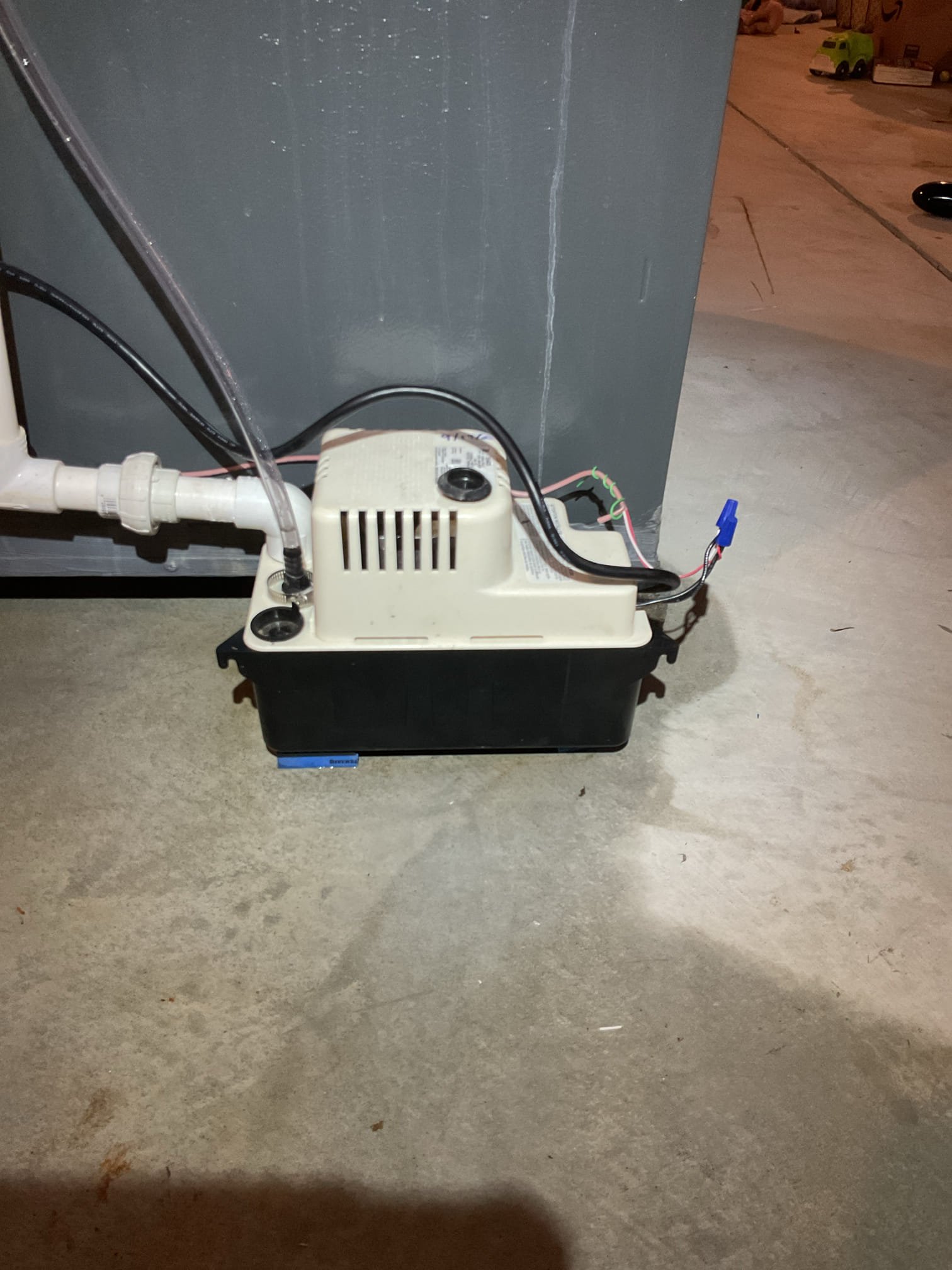 Water on floor near condensate pump.
Tested drains by pouring directly into evaporator pan. 
Found that pump needed to be kicked or tapped to run when full.

Provided estimate to replace 115V condensate pump and the 3/8” vinyl discharge tubing.

Homeowner agreed. 
Replaced both and put new pump on cork pad risers and installed 3/4” PVC union to allow for easy service and cleaning of new pump.
*I was 3-4’ short on vinyl tubing so I spliced. This small section of tubing is in very good condition. I wired in condensate pump safety as a courtesy. 

Tested new pump 3 times by pouring water directly into evaporator drain pan.

System operating well at this time, 