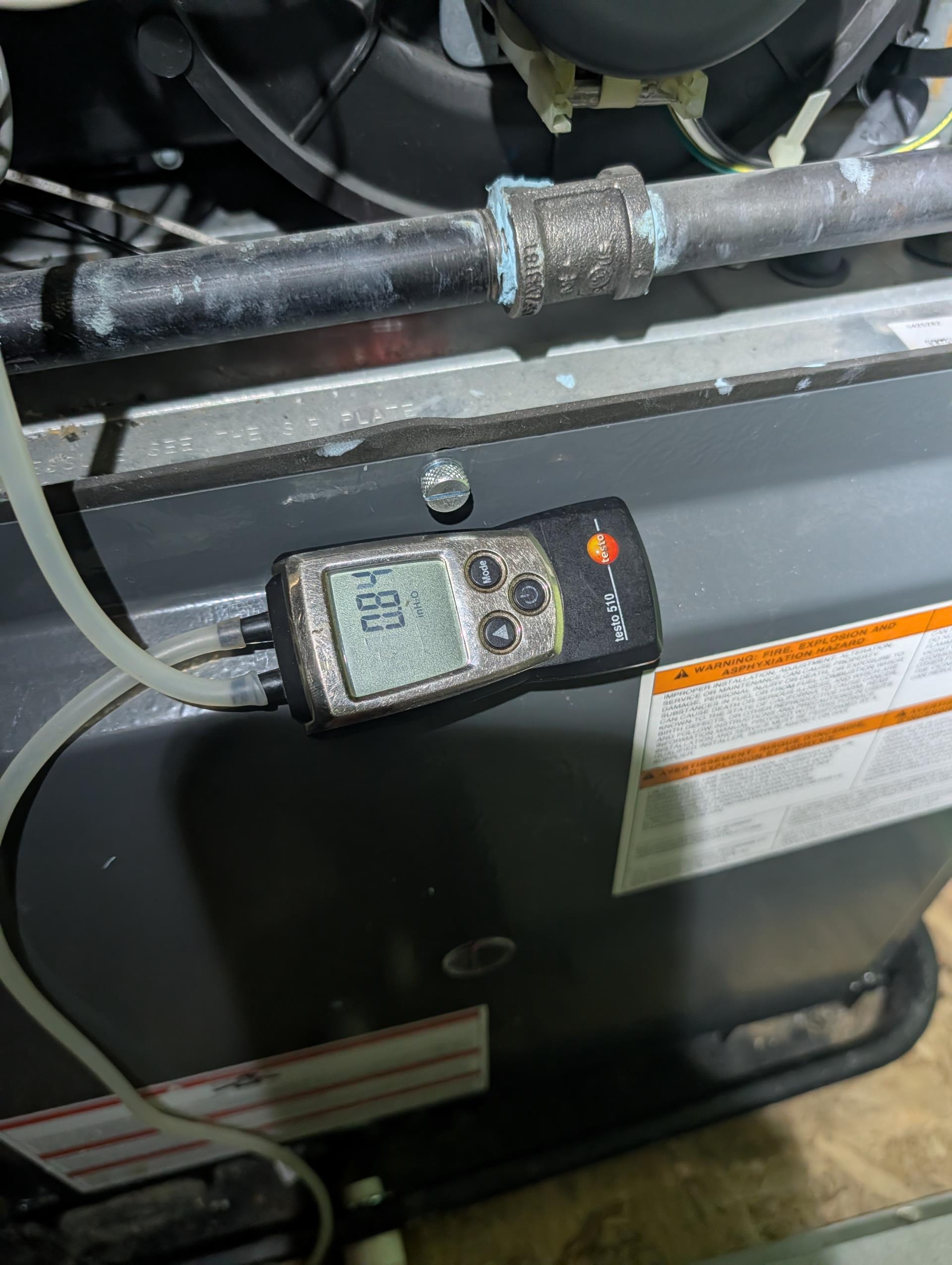 I performed a comprehensive heat tune-up on a natural gas furnace installed in a 2022-built home. I demonstrated to the homeowner how to offset the Ecobee thermostat by 2°. The 16x25x1 filter was in good condition, and I left an additional one on site. I inspected the heat exchanger, burners, flue pipe, inducer assembly, and hoses. The hot surface ignitor was verified with a meter, and the flame sensor was cleaned, ensuring the flame rectification circuit functioned correctly. I measured the temperature rise and static pressure, checked wiring, controls, electric motors, and components, and noted the absence of surge protectors, leaving an estimate for one. I also checked manifold gas pressure and inspected drains, providing an estimate for AC drain pan overfill protection and a wet switch. Combustion, draft, and smoke tests passed. Additionally, I provided estimates for an air ranger electrostatic air filter system and an APCOX whole home air treatment system. The furnace is currently