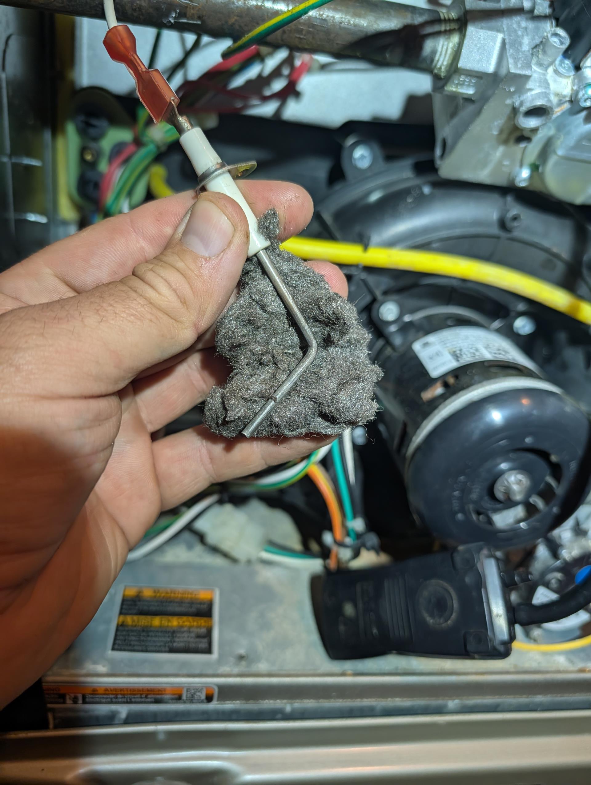I performed a comprehensive heat tune-up for the natural gas furnace, which is 4 years old. I checked the 16x25x1 filter and found it to be in good condition. I inspected the heat exchanger, burners, flue pipe, inducer assembly, and hoses for any signs of wear or damage. The hot surface ignitor was inspected, and its resistance was verified using a meter. The flame sensor was cleaned, and the flame rectification circuit was checked. I measured the temperature rise and static pressure, and checked the wiring, controls, electric motors, and components, noting the presence of surge protection. The manifold gas pressure was 9.98 inches, and I checked for gas leaks from the furnace shutoff valve to the furnace, finding none. I also inspected and cleaned the drains, brushing out the EZ trap and cleanout. Combustion, draft, and smoke tests all passed. I provided an estimate for a Defender Low-level Carbon Monoxide detector, which the homeowner agreed to. It was installed in the finished basem