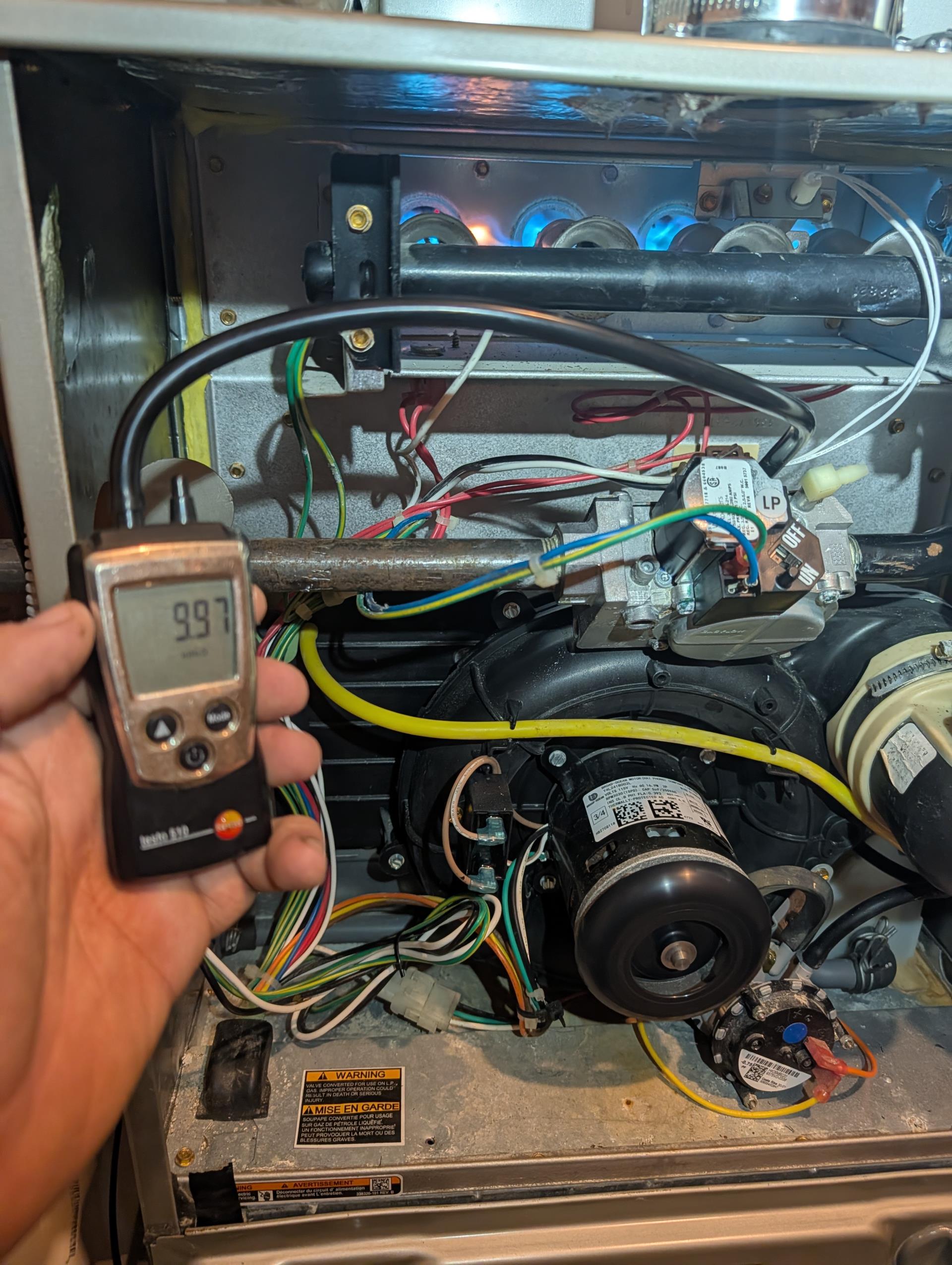 I performed a comprehensive heat tune-up for the natural gas furnace, which is 4 years old. I checked the 16x25x1 filter and found it to be in good condition. I inspected the heat exchanger, burners, flue pipe, inducer assembly, and hoses for any signs of wear or damage. The hot surface ignitor was inspected, and its resistance was verified using a meter. The flame sensor was cleaned, and the flame rectification circuit was checked. I measured the temperature rise and static pressure, and checked the wiring, controls, electric motors, and components, noting the presence of surge protection. The manifold gas pressure was 9.98 inches, and I checked for gas leaks from the furnace shutoff valve to the furnace, finding none. I also inspected and cleaned the drains, brushing out the EZ trap and cleanout. Combustion, draft, and smoke tests all passed. I provided an estimate for a Defender Low-level Carbon Monoxide detector, which the homeowner agreed to. It was installed in the finished basem