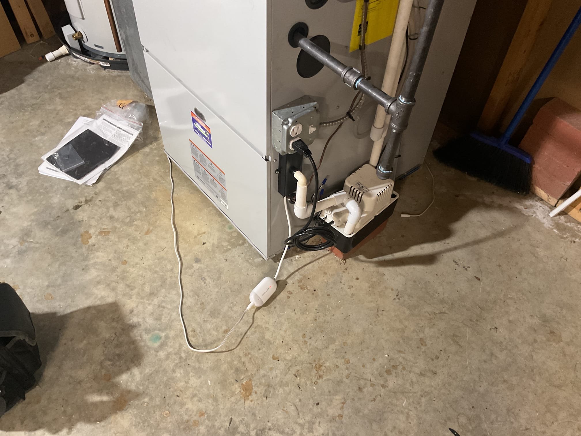 On October 15, I was called to address a persistent issue with a WiFi leak detection sensor. The homeowner reported that the sensor was continuously beeping. Upon inspection, I found that the sensor was indeed active. I disconnected the rope from the detector, and upon examination, there was no water present on the floor. I then pulled the rope around the furnace to ensure it was not causing any false readings. After confirming that everything was dry, I re-ran the rope around the furnace and reset the detector by pressing the reset button on its side. The alarm ceased, but it started beeping again after some time. I unplugged the rope, and the alarm stopped, indicating a defect in the rope. I left the leak sensor on site, as it functions without the rope, and advised the homeowner to return the defective rope under warranty for replacement.