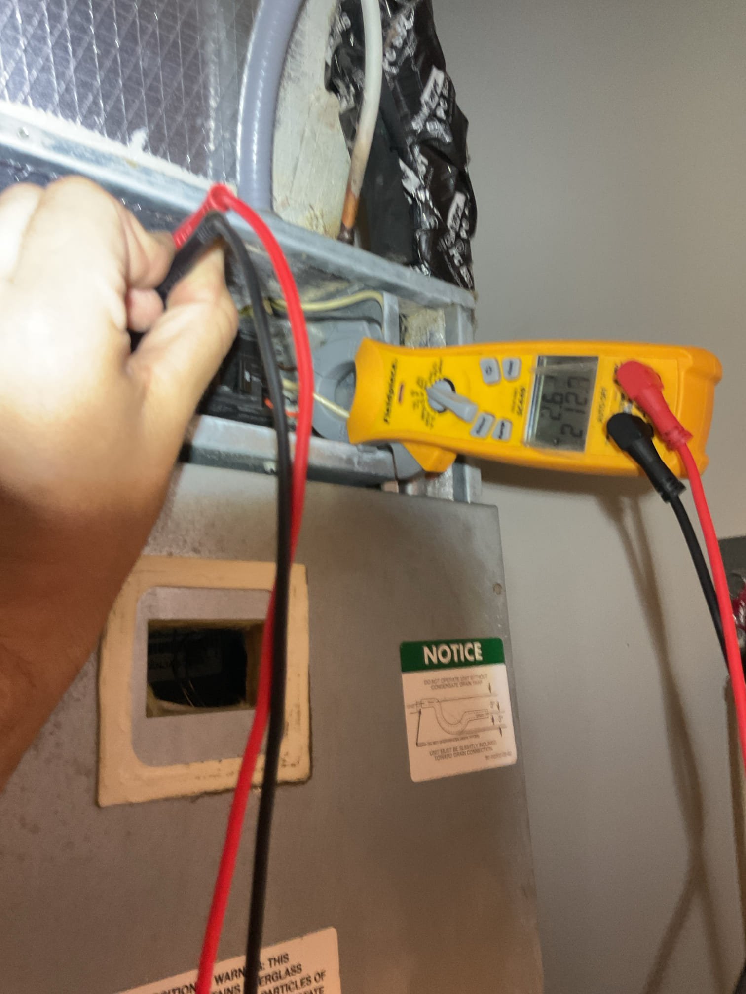 Upon inspection, I discovered that the left back side of the duct board plenum was detached. Additionally, there was water under the filter and on the insulation of the coil compartment. Jaylen from AtWater assisted by clearing the drain line, which was suspected to be the cause of the water accumulation. I secured the plenum using duct board tape and proceeded to test the system. The voltage was measured at 212, and I connected the primary lead to the 208V tap. The system test showed a perfect temperature split of 18°, and the secured duct board remained intact during testing. However, on two occasions, the blower motor unexpectedly dipped in RPM before gradually returning to full speed. This issue occurs randomly and is not tied to any specific cycle. The blower motor appears to be failing and should be replaced soon. I have emailed an estimate for this and charged for the diagnostic today.