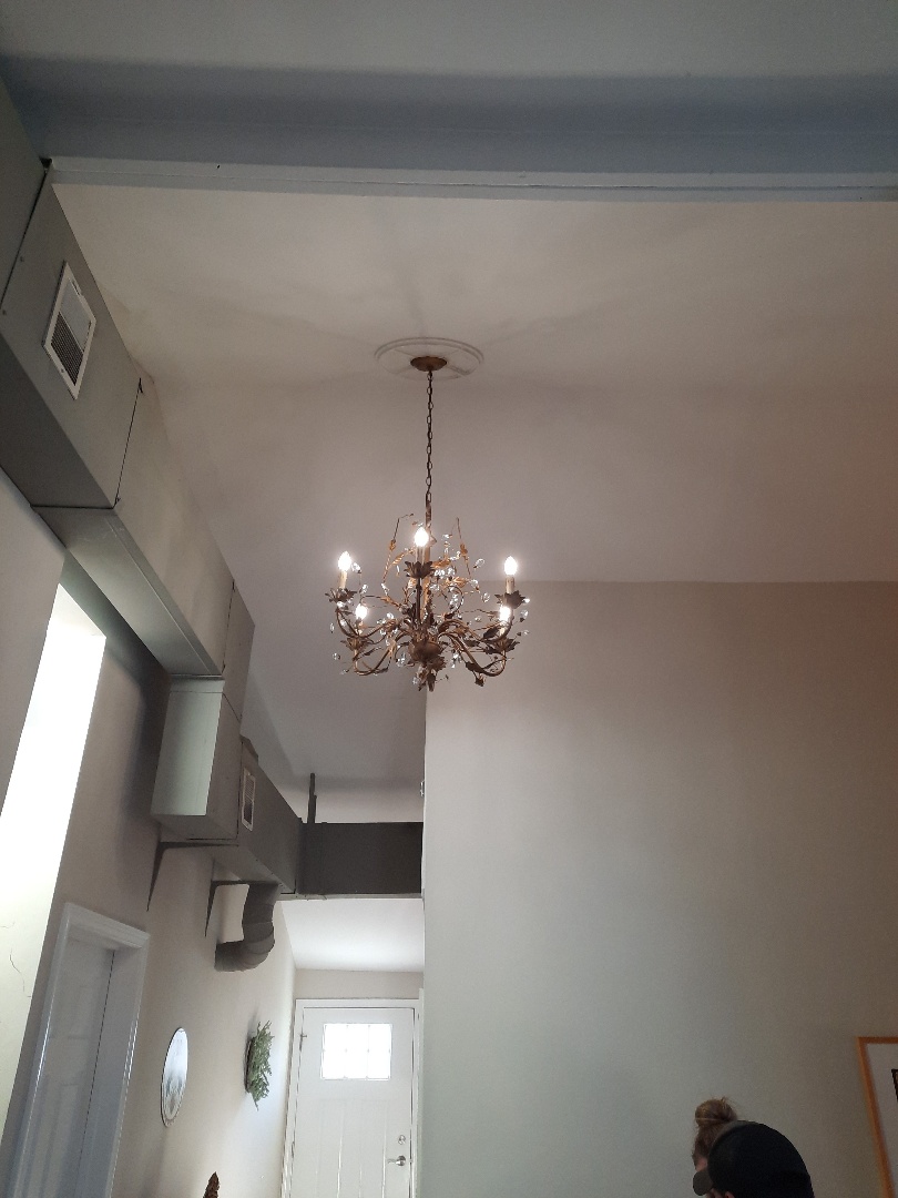 Fan on sloped ceiling replaced with chandelier.
Riva, MD