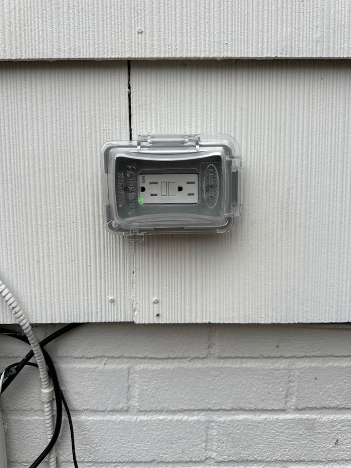 Installed outdoor GFCI receptacle and in use cover in Baltimore, MD. 
