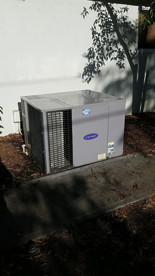 Woodland, CA - Ac rejuvenation on a 19 year old carrier package unit on the ground. Woodland, CA - Ac rejuvenation on a 19 year old carrier package unit on the ground.