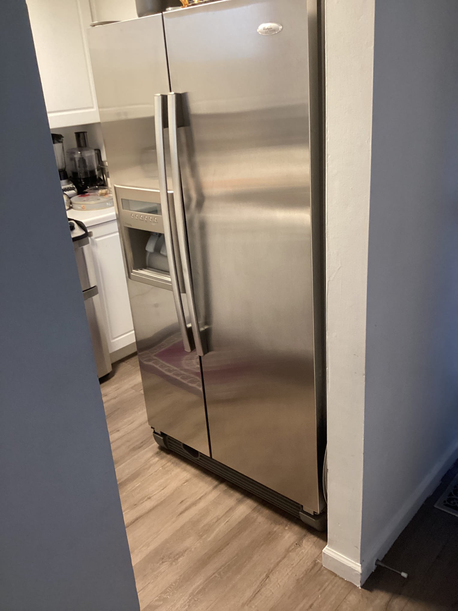 The unit is in a small humid kitchen with grocery bags blocking the return air flow. As a result, the still air is frosting and blocking air vents.