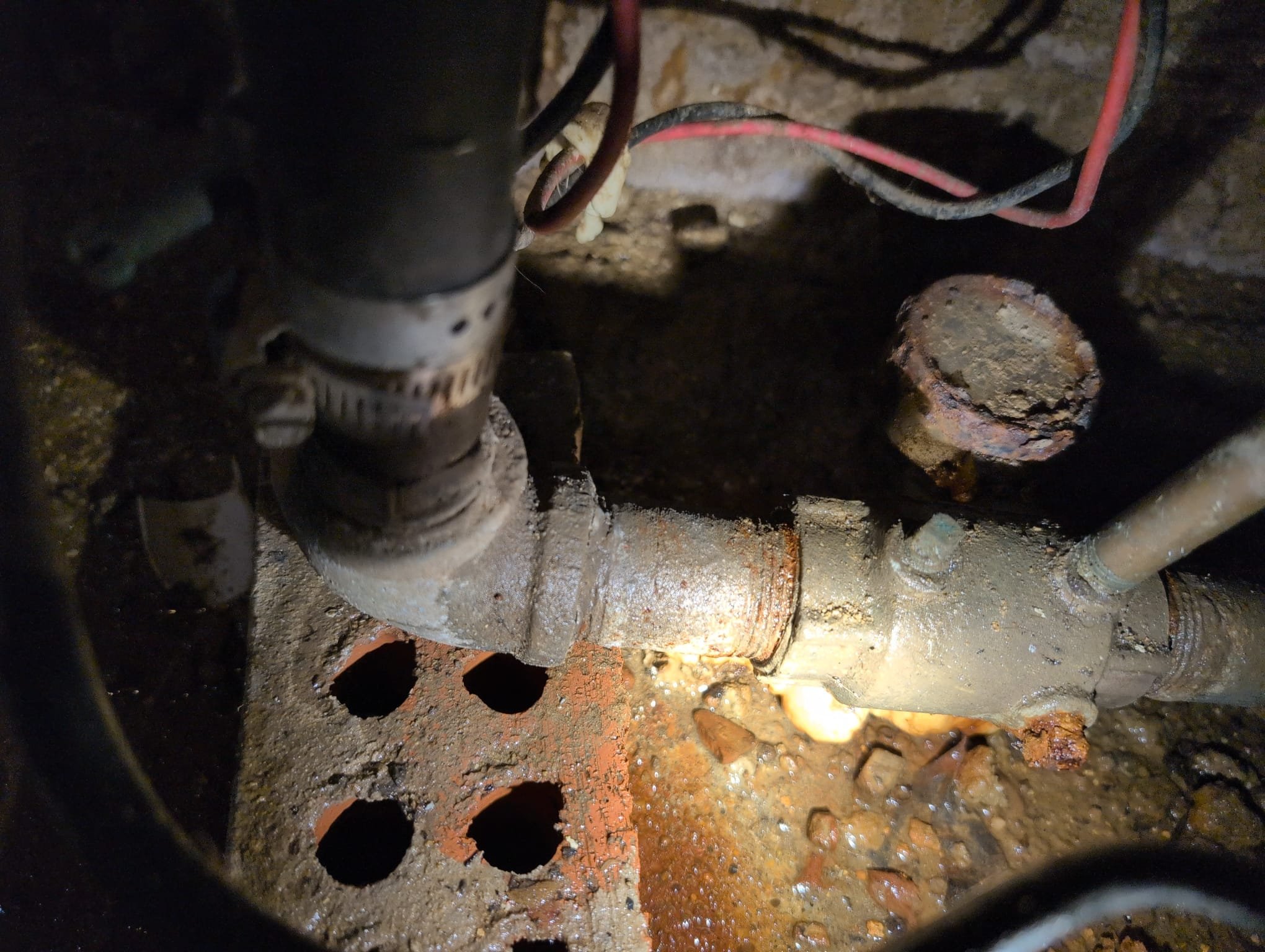 I was called to a home to fix a pressure tank line that was not installed properly. The line coming out of the pressure tank had a small crack in the nipple at the 90 it came up to. I replaced the pressure gauge and the 90, and removed the union as well. The water lines were polybutylene.