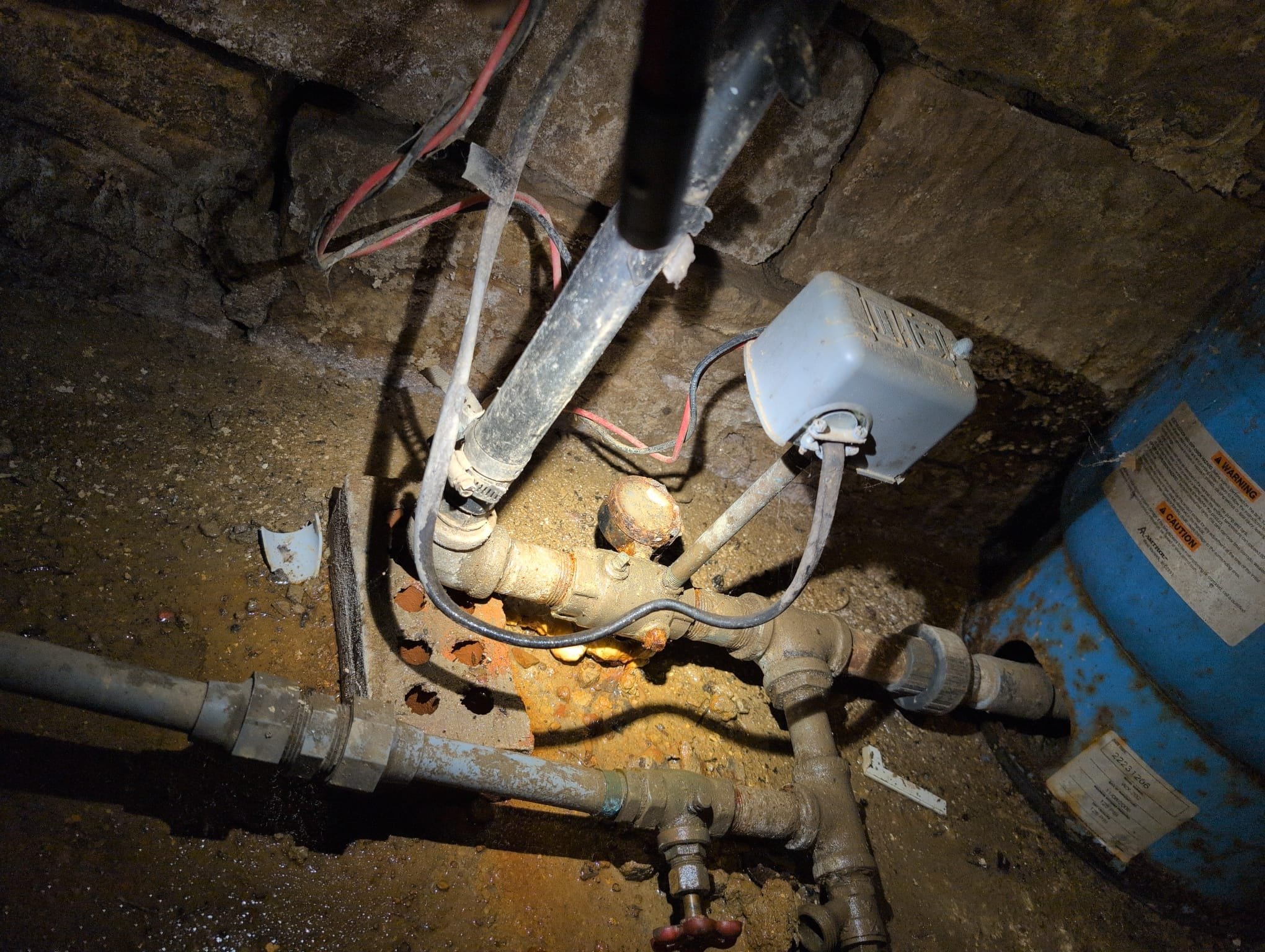 I was called to a home to fix a pressure tank line that was not installed properly. The line coming out of the pressure tank had a small crack in the nipple at the 90 it came up to. I replaced the pressure gauge and the 90, and removed the union as well. The water lines were polybutylene.