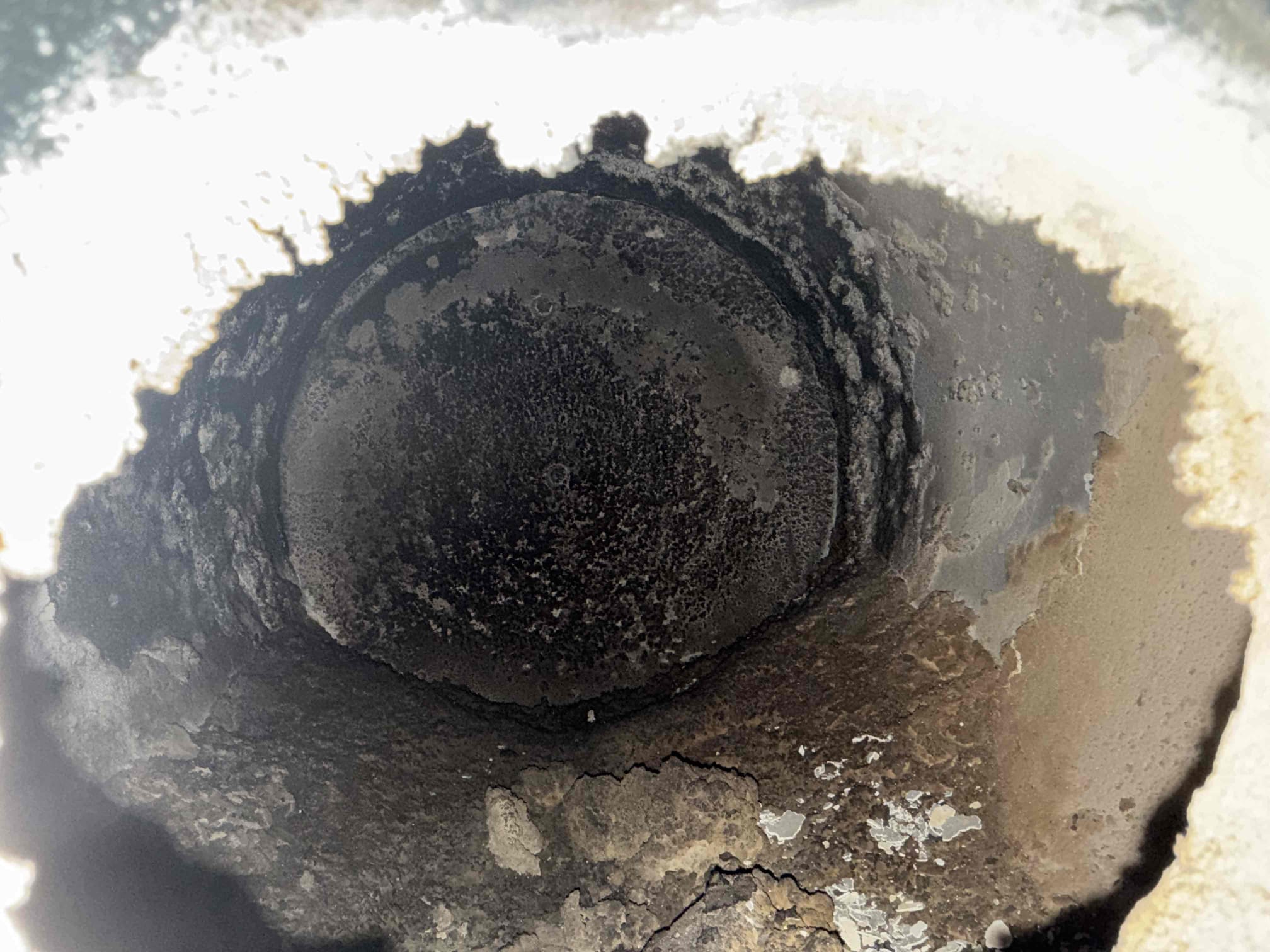 The system was not operating properly, and the burner cavity and flue were full of unburned oil and debris. I was called to the site to clean out the burner cavity and flue, which was a time- and material-intensive job.