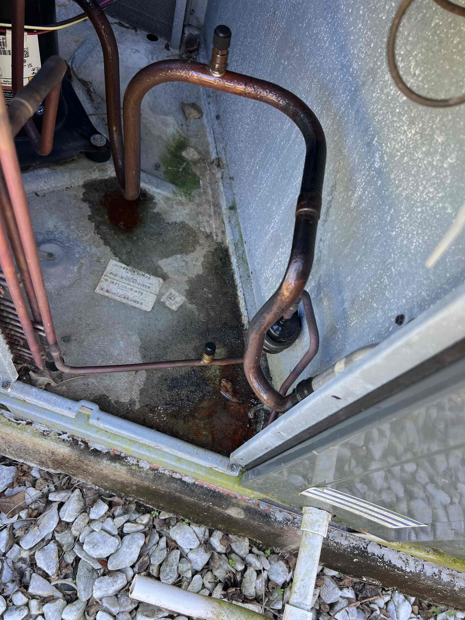 I went through the system and cleaned the drain pan and drain trap again. Inside the unit was damp, but no standing water like before. The system was dry all around and nothing was leaking. There was water in the area where the condenser coil is because the lines are not insulated. I poured bottles of water into the drain pan and let it drain. The drain pan did not overflow. The system is cooling correctly.