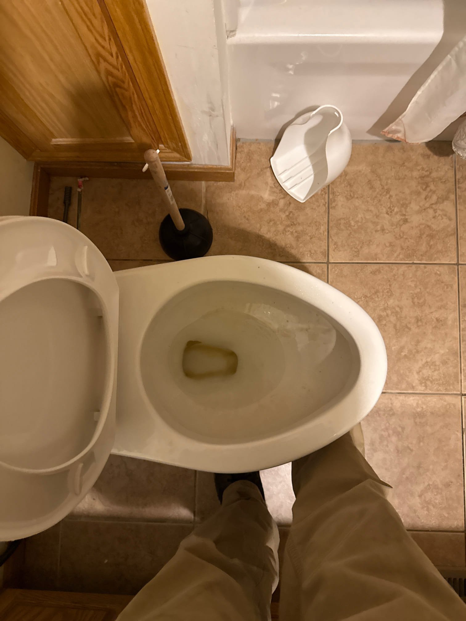 Run toilet auger through the toilet to try and clear blockage. 