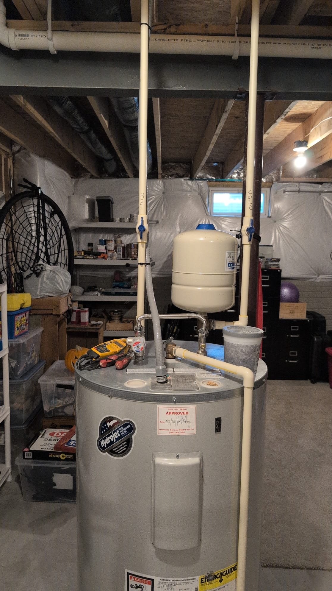Today, I was called to address an issue with a Bradford White 50-gallon electric water heater installed in 2018. Upon inspection, the water heater appeared to be in excellent condition, which is typical for this model. I tested both the top and bottom heating elements, which showed a resistance of 13 ohms, indicating they are functioning correctly. Additionally, I checked the top and bottom thermostats for continuity, confirming they are operational. Although there was a slight possibility of a crack in one of the thermostats, it was likely calcified, which could mask internal issues. Given the water heater's age, I recommended a replacement for better efficiency. I provided estimates for repair, replacement, and a tankless option, which the client expressed interest in. The client decided to consult with their spouse before making a final decision.