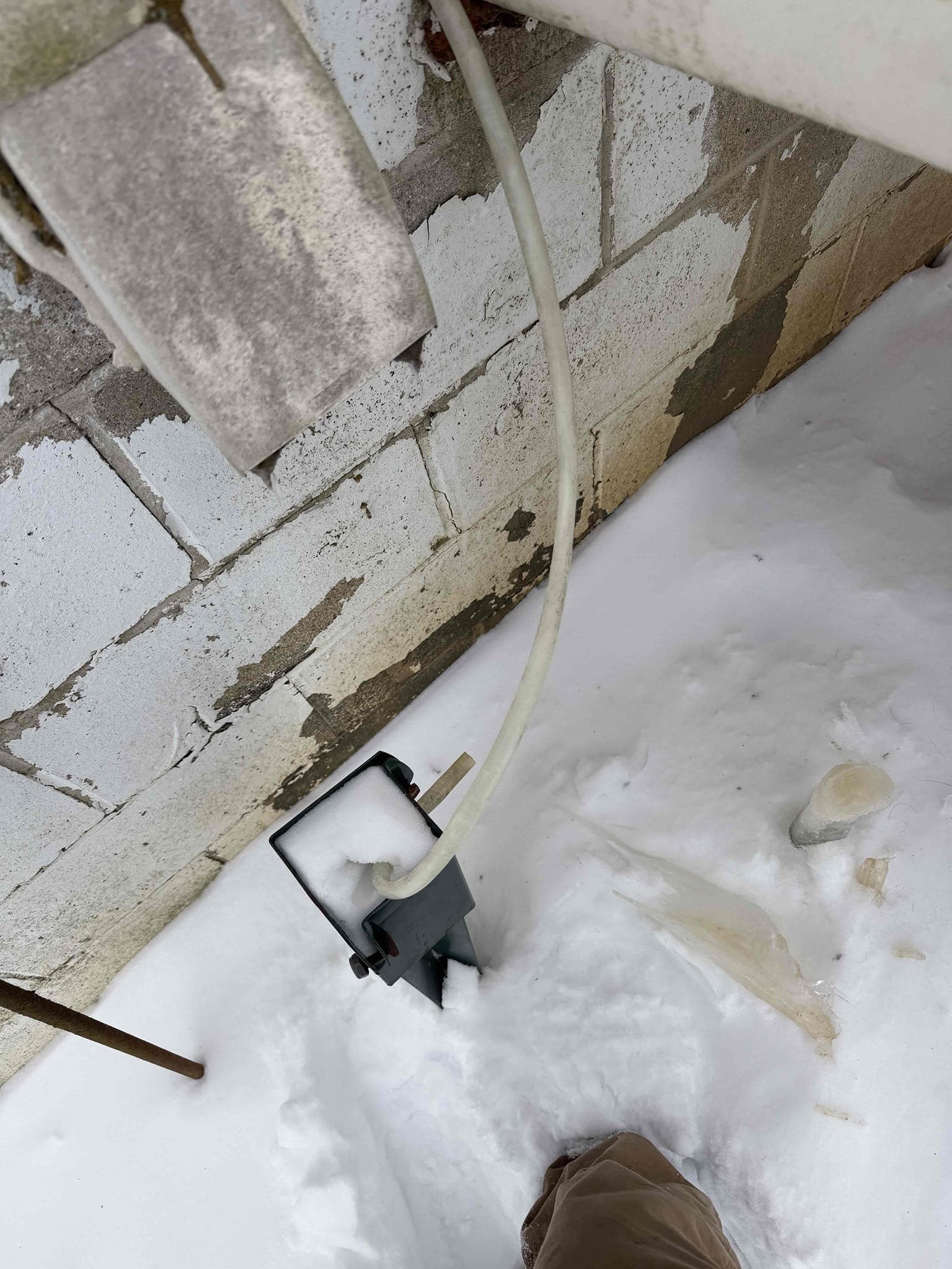 Upon inspection, I discovered that the outdoor drain tube had frozen solid, preventing proper drainage. To address this issue, I first assessed the extent of the freezing and identified the need for a more durable solution. I then returned with vinyl tubing, which is less susceptible to freezing temperatures. The tubing was carefully installed to ensure a secure fit and proper drainage path. This solution will allow the system to drain effectively indoors, safeguarding against future freezing and ensuring the client's system operates smoothly. The installation was completed efficiently, and the client now has a reliable drainage system.