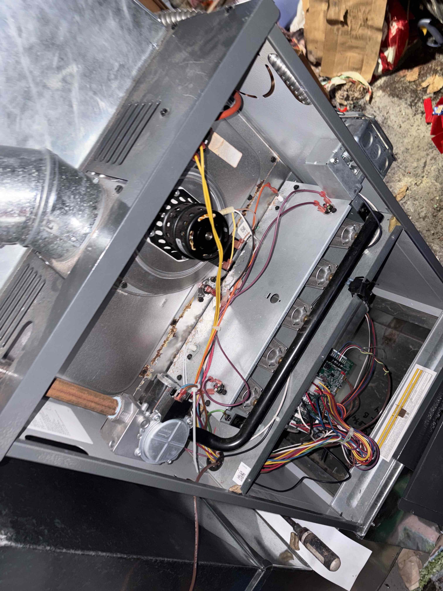 Upon inspection, the heating system installed a year ago was not functioning. Initially, a faulty thermostat was identified, but further examination revealed an improperly angled flue pipe, leading to condensation buildup in the furnace. This condensation had caused the heat exchanger to rust severely. I informed the customer of the necessary replacement of the furnace with a high-efficiency model and ensured proper flue venting. An estimate for the replacement has been emailed to the customer.