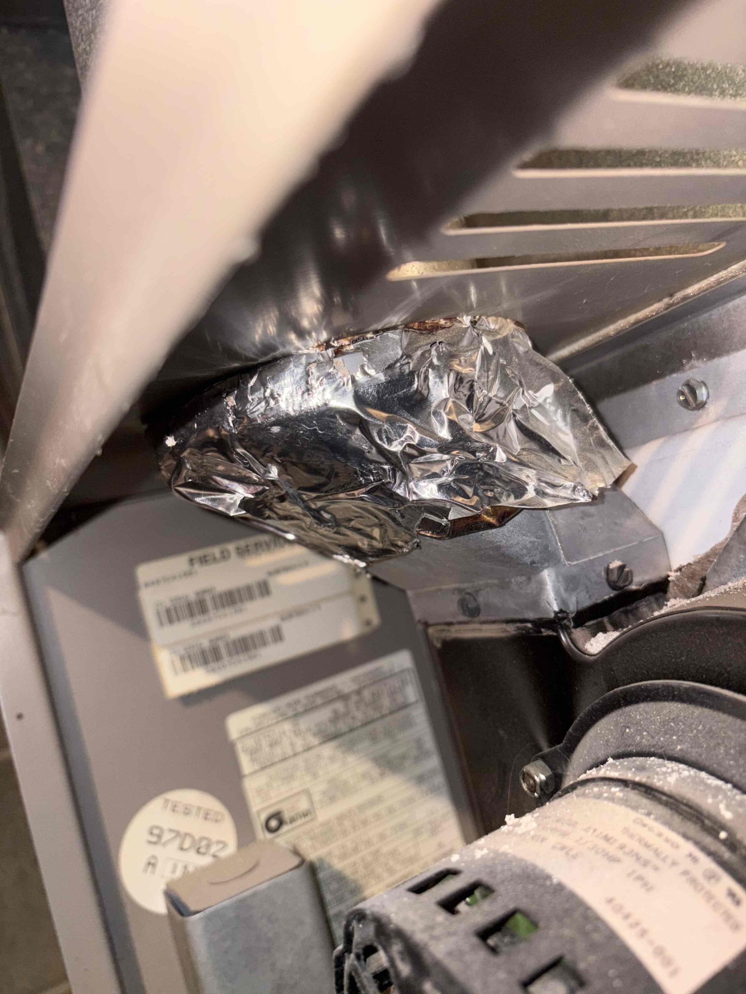 water was leaking from the flue pipe, which was causing carbon monoxide to enter the home. A thorough examination revealed multiple holes in the flue pipe, compromising its integrity. Given the unit's age, condition, and the extent of the water damage, we recommended a replacement. We red-tagged the unit and informed the customer of this necessity. They agreed and signed an estimate for a high-efficiency furnace installation, scheduled for the next afternoon. To prevent potential freezing, we left two heaters with the customer. We will return once it is safe to access the roof and determine the root cause of the water leak.