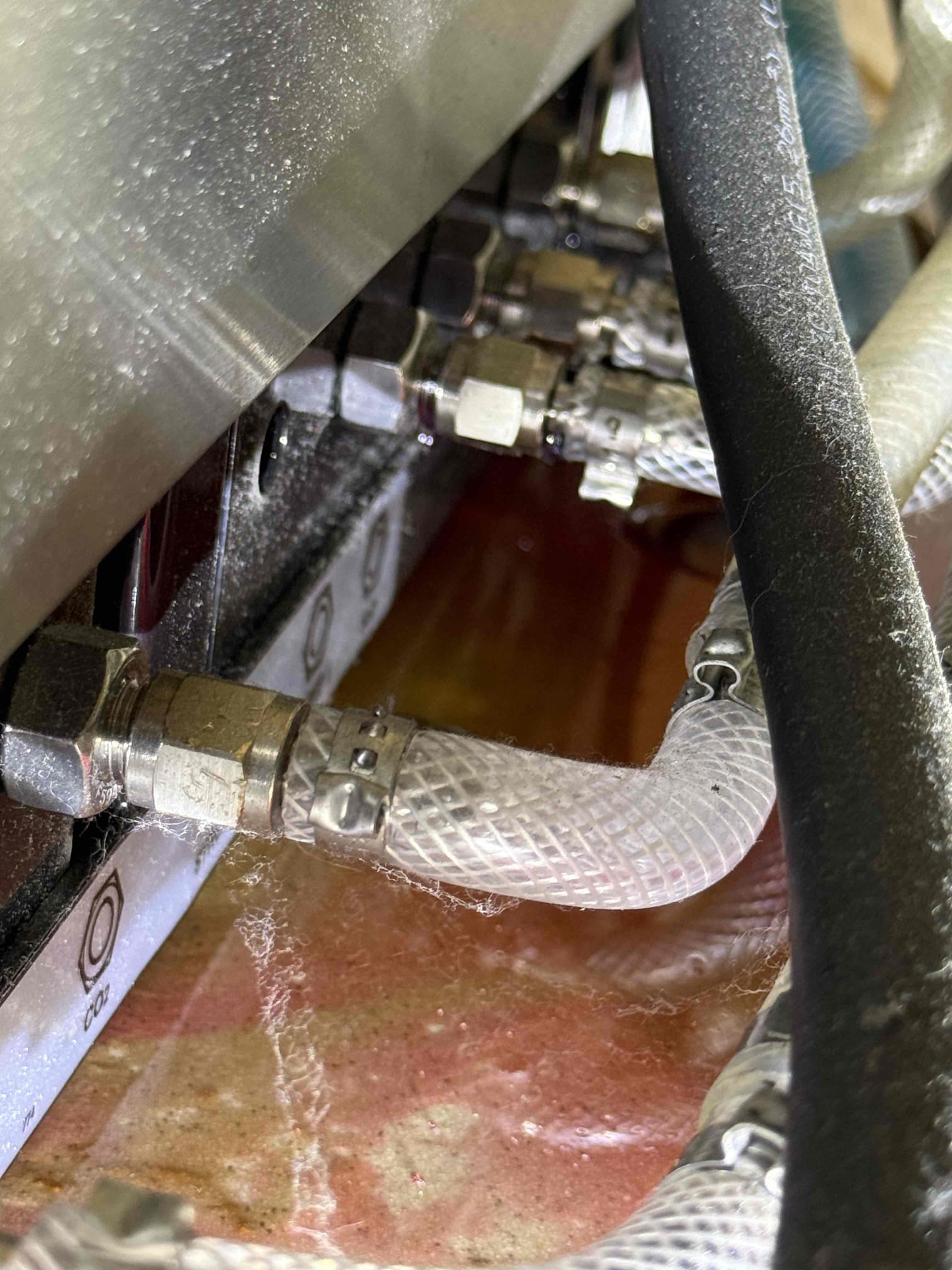 Upon inspection, I identified loose syrup lines at the back of the unit, causing a leak. I meticulously resealed the affected lines, ensuring a secure and tight connection. The system was tested post-repair, confirming that the leak had ceased. The unit is now functioning properly, with no signs of leakage.