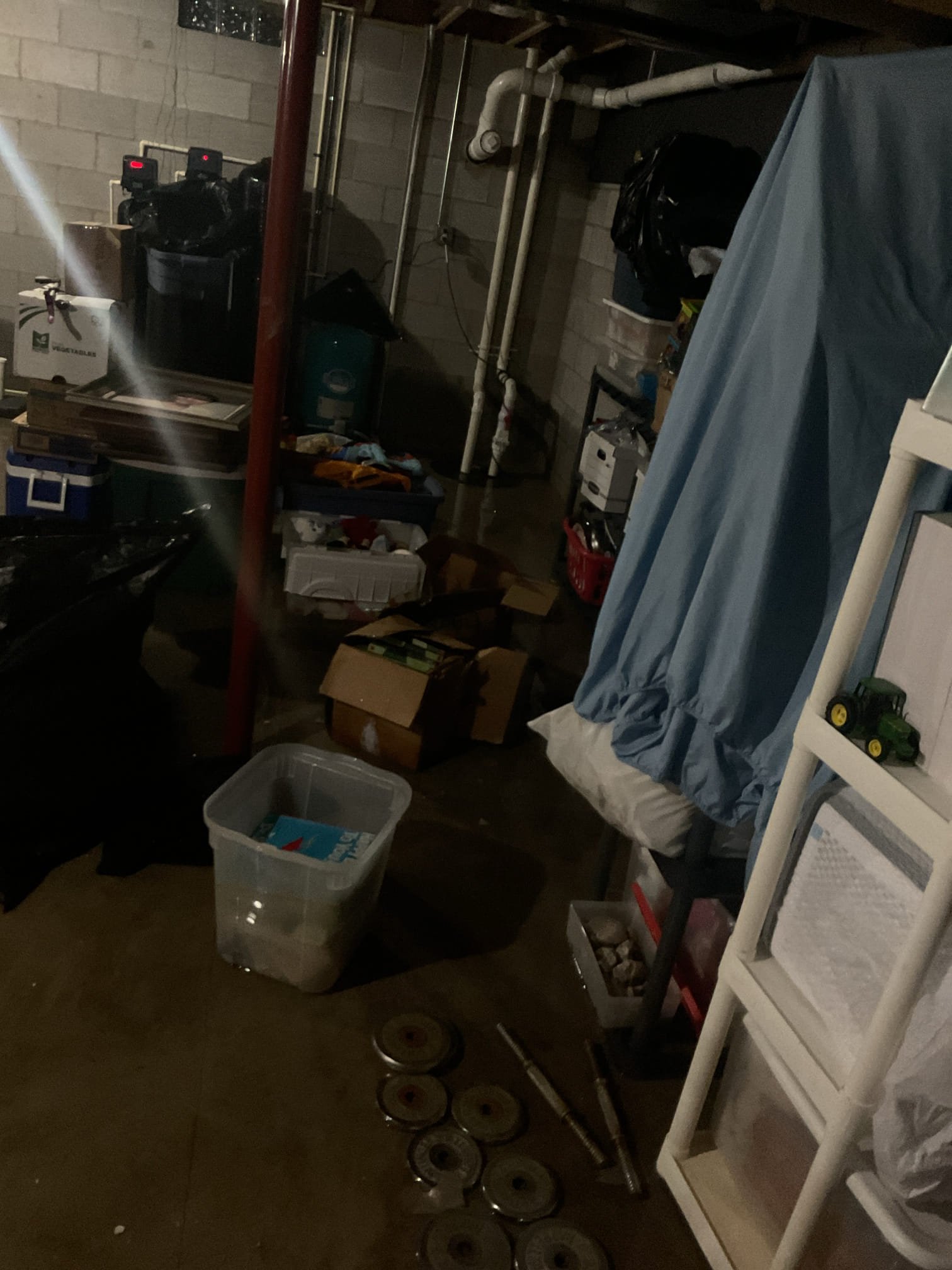 Upon arrival, I found the basement water level at an inch, though it had previously reached knee height. I thoroughly inspected the plumbing system, which was accessible due to the open ceiling and basement size. No leaks or drips were observed in the drainage system when the house was fully operational. Both water heaters appeared functional, though they had absorbed some water. The sump pump, three years old, was initially off, but it activated immediately upon turning the breaker back on, effectively managing the water. The grinder pump also operated intermittently. Based on these observations, the flood was likely due to a tripped sump pump and grinder pump, possibly caused by a storm-induced power flicker. The client plans to have HVAC inspected for proper functioning.